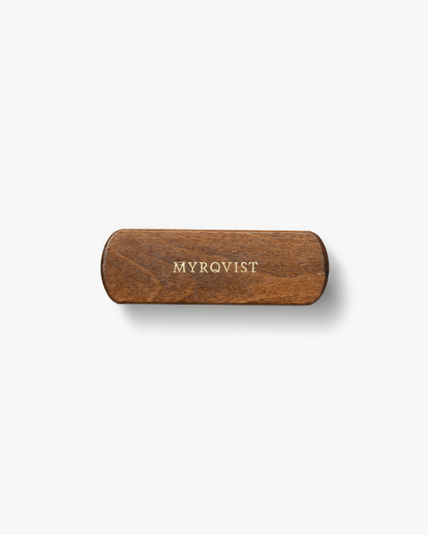 Overhead view of the Myrqvist shoe brush, showing the dark brown, varnished wooden handle with the logo in gold.