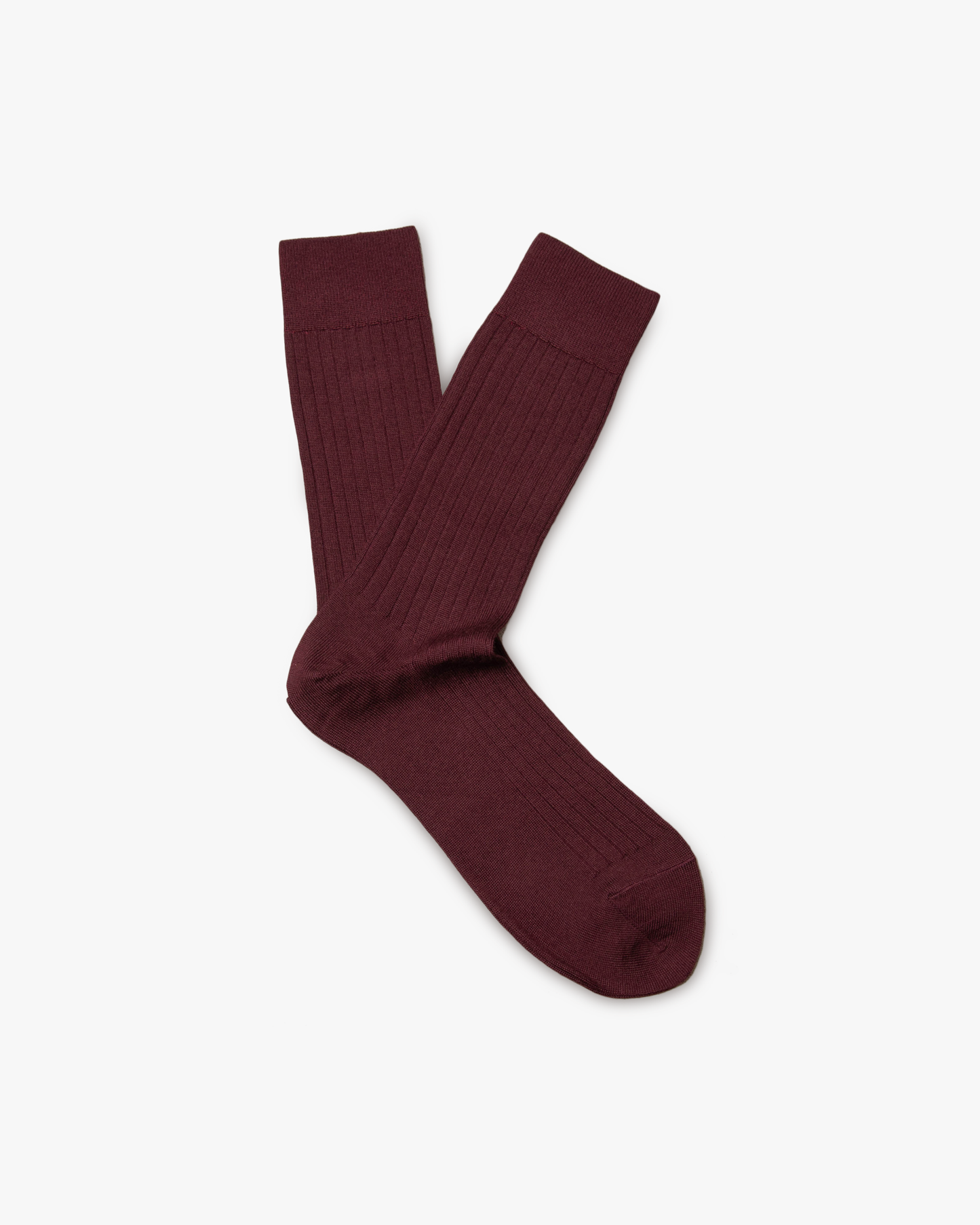 A pair of Ludvig – Merino Wool Socks in burgundy, laid flat against a white background.