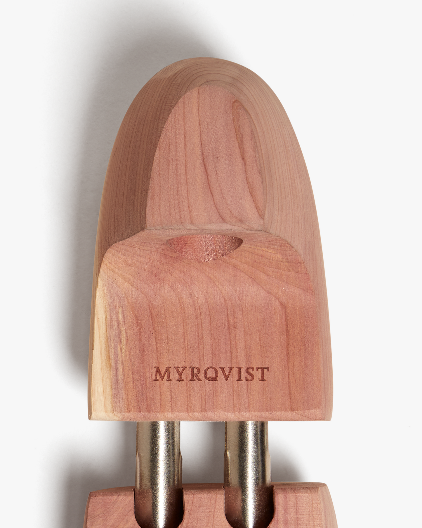 Close-up of the Myrqvist shoe tree in cedar wood, highlighting the engraved branding, smooth finish, and natural wood grain designed to maintain shoe shape and absorb moisture.