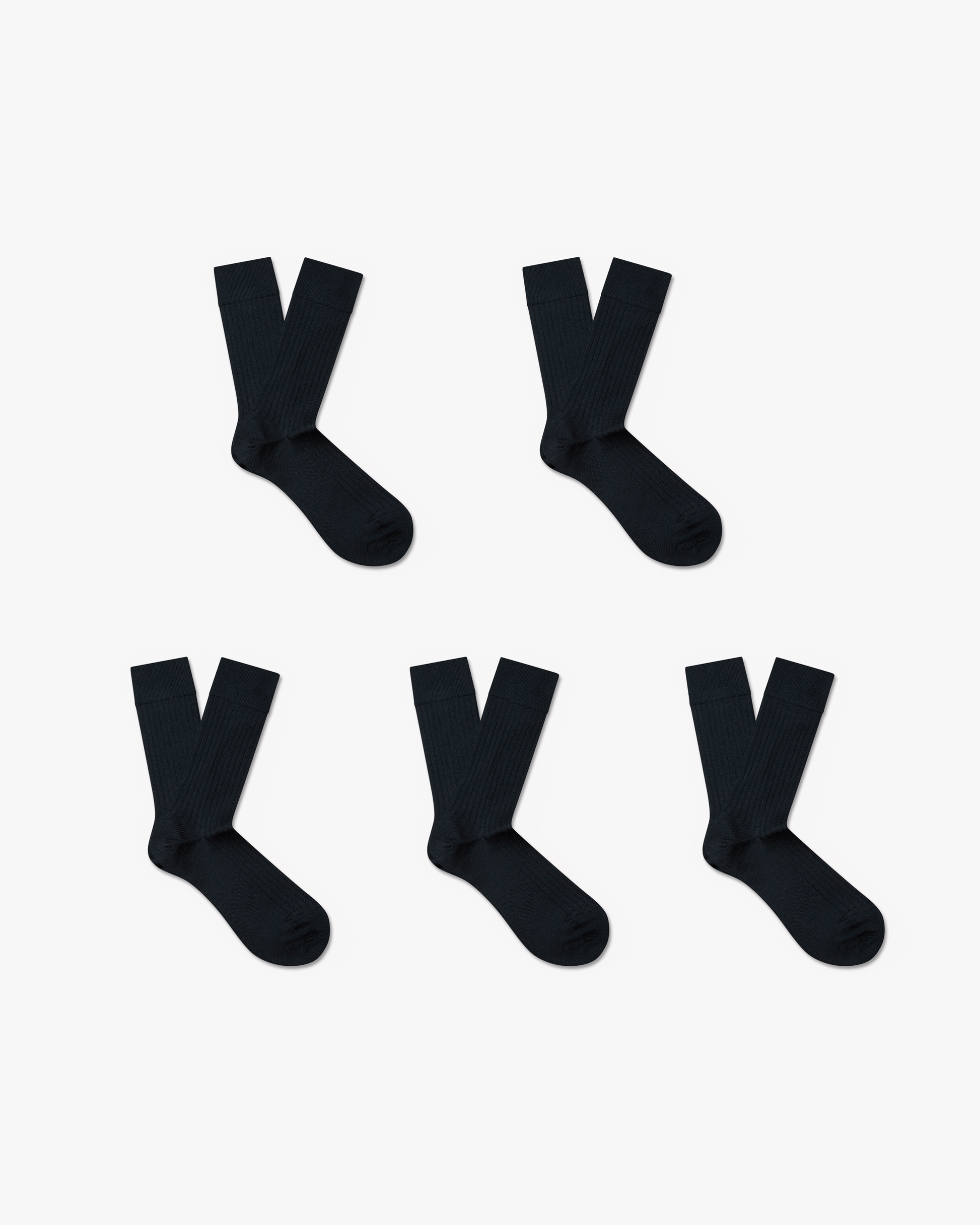 Five pairs of Ludvig merino wool socks in classic black, featuring a ribbed, calf-high design arranged neatly against a white background.