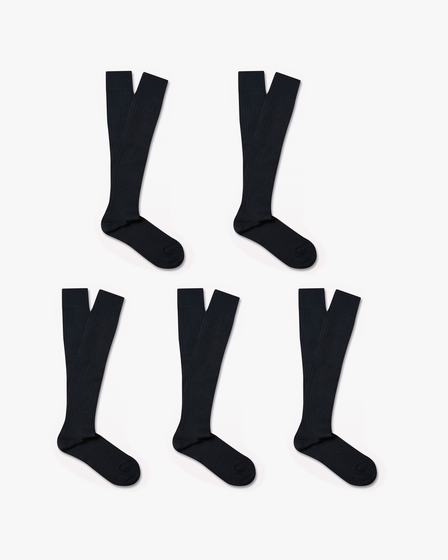 Five pairs of Gustav knee-high merino socks in classic navy are arranged on a white background, featuring a ribbed texture and over-the-calf length for a polished, versatile look.