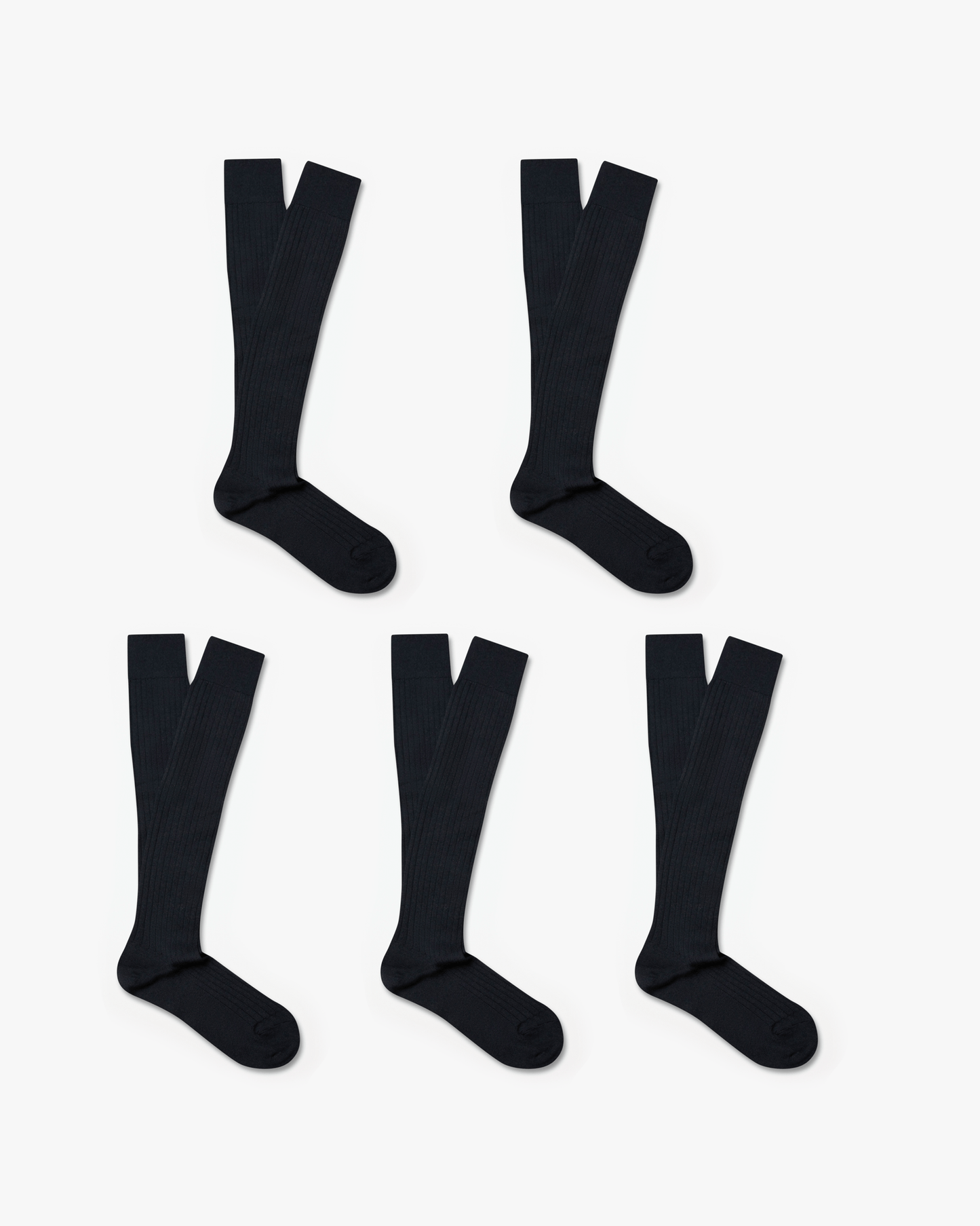 Gustav knee-high merino socks in dark charcoal, arranged in a set of five pairs, feature a ribbed design and over-the-calf length ideal for pairing with tailored trousers or slacks.