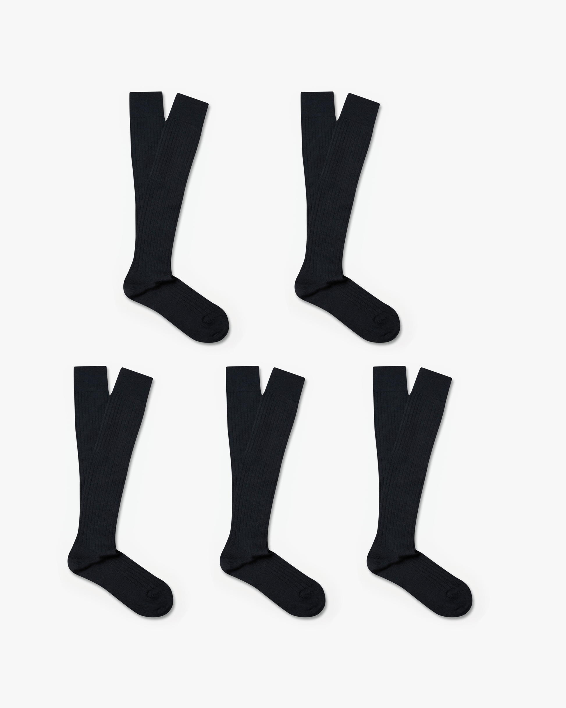 Gustav knee-high merino socks in dark charcoal, arranged in a set of five pairs, feature a ribbed design and over-the-calf length ideal for pairing with tailored trousers or slacks.