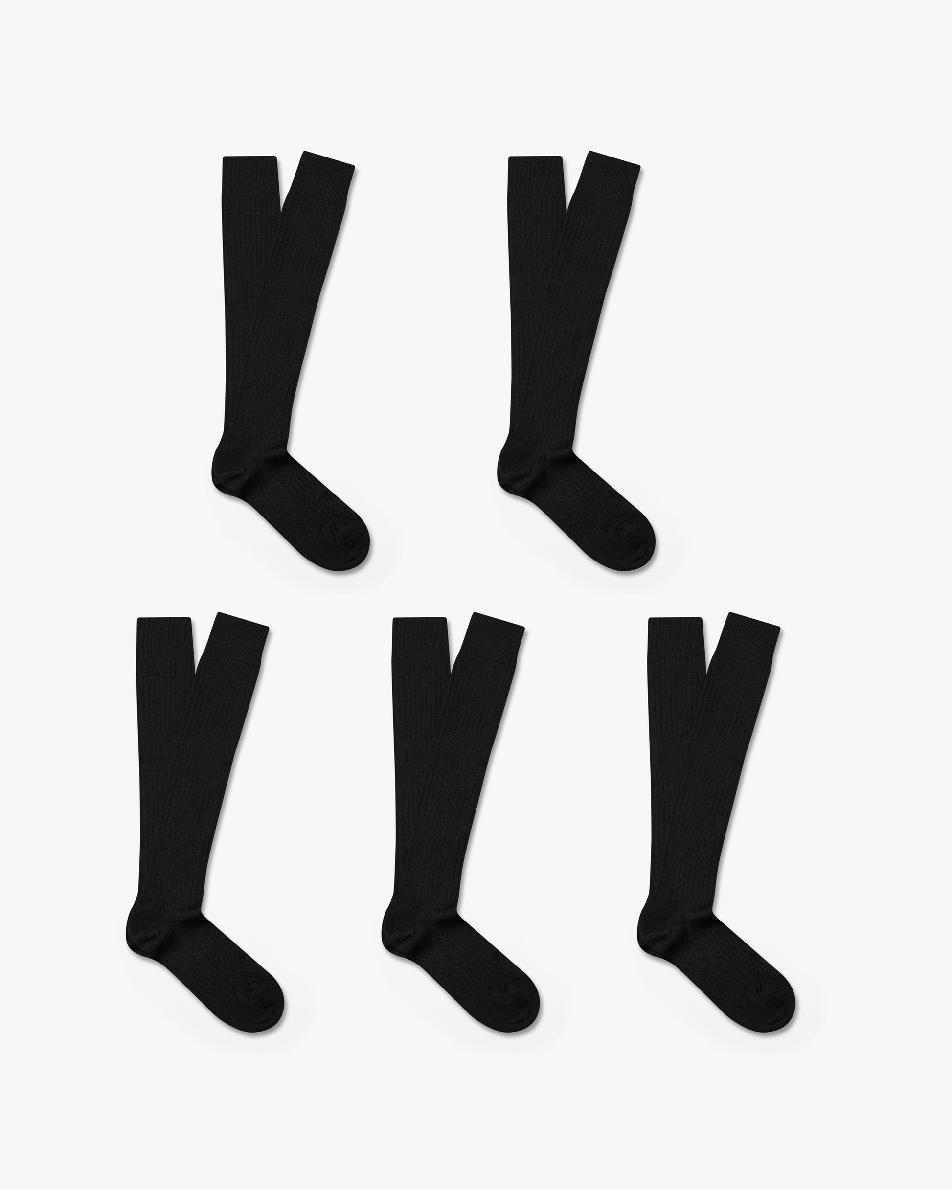 Five pairs of Gustav knee-high merino socks in classic black are displayed on a white background, highlighting their ribbed texture and over-the-calf fit for a polished, versatile style.