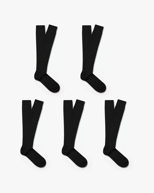 Five pairs of Gustav knee-high merino socks in black are neatly arranged on a white background, showcasing their ribbed texture and over-the-calf length.