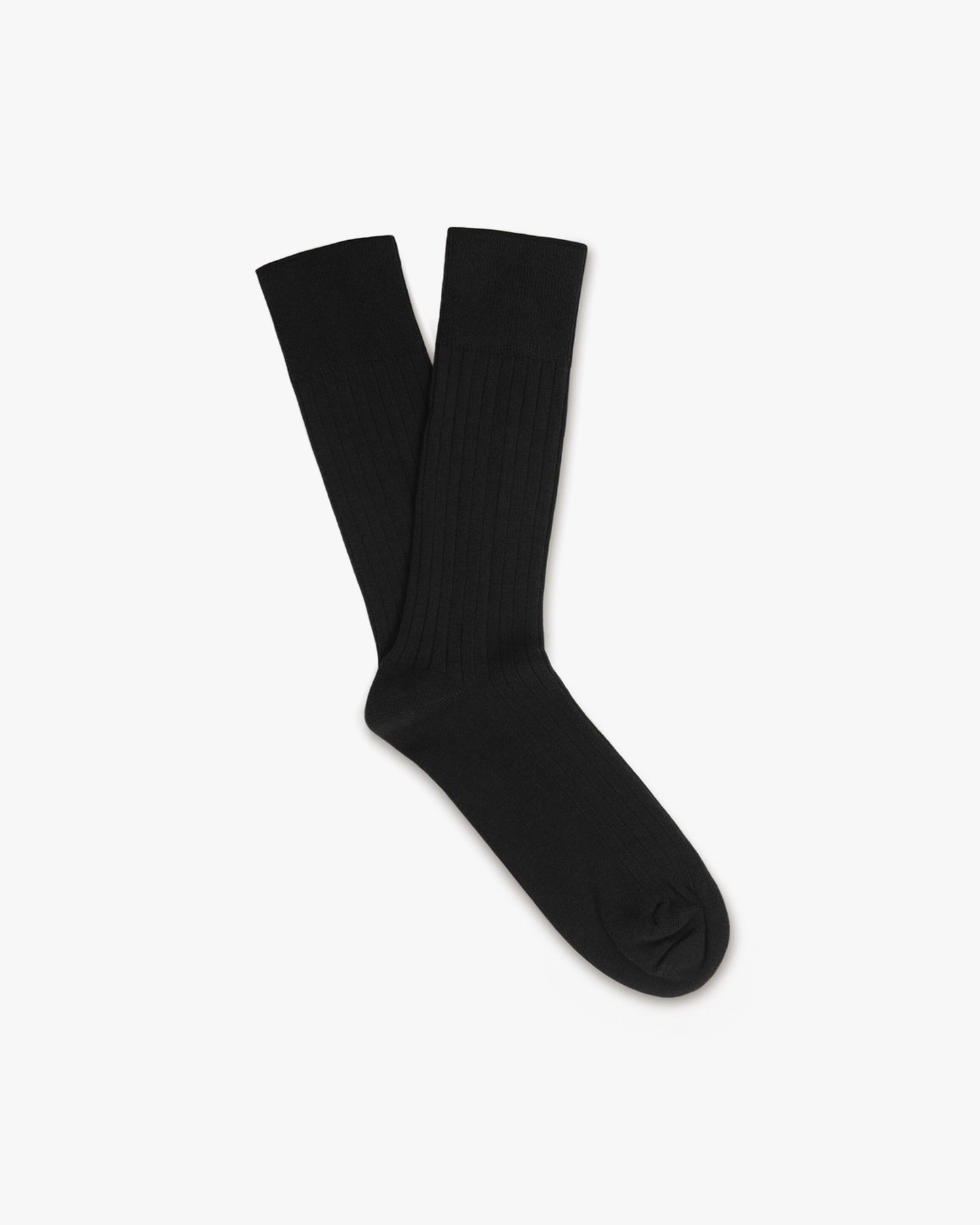 Oscar ribbed cotton socks in black, featuring a classic crew silhouette and subtle ribbing for a polished look that pairs well with dress shoes, slacks, or denim.