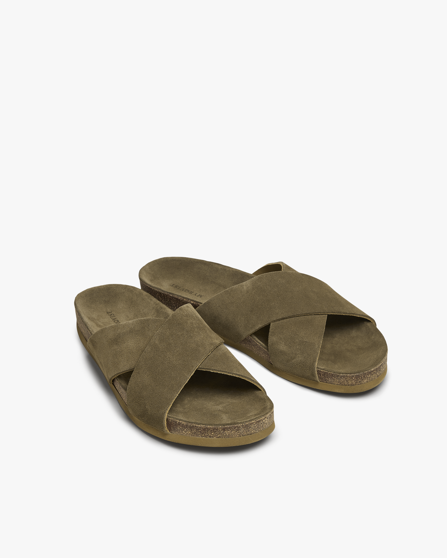 Solvik men’s sandals in moss green suede, featuring wide cross-over straps, an open toe, and a moulded cork footbed with a slim sole, presented at a three-quarter angle to highlight the natural texture and minimalist design.