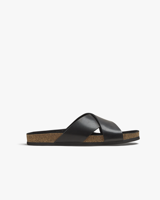 Solvik sandal in black calf features broad, cross-over leather straps and an open toe, set on a moulded cork footbed with a slim black outsole, offering a refined and versatile look for warm-weather dressing.