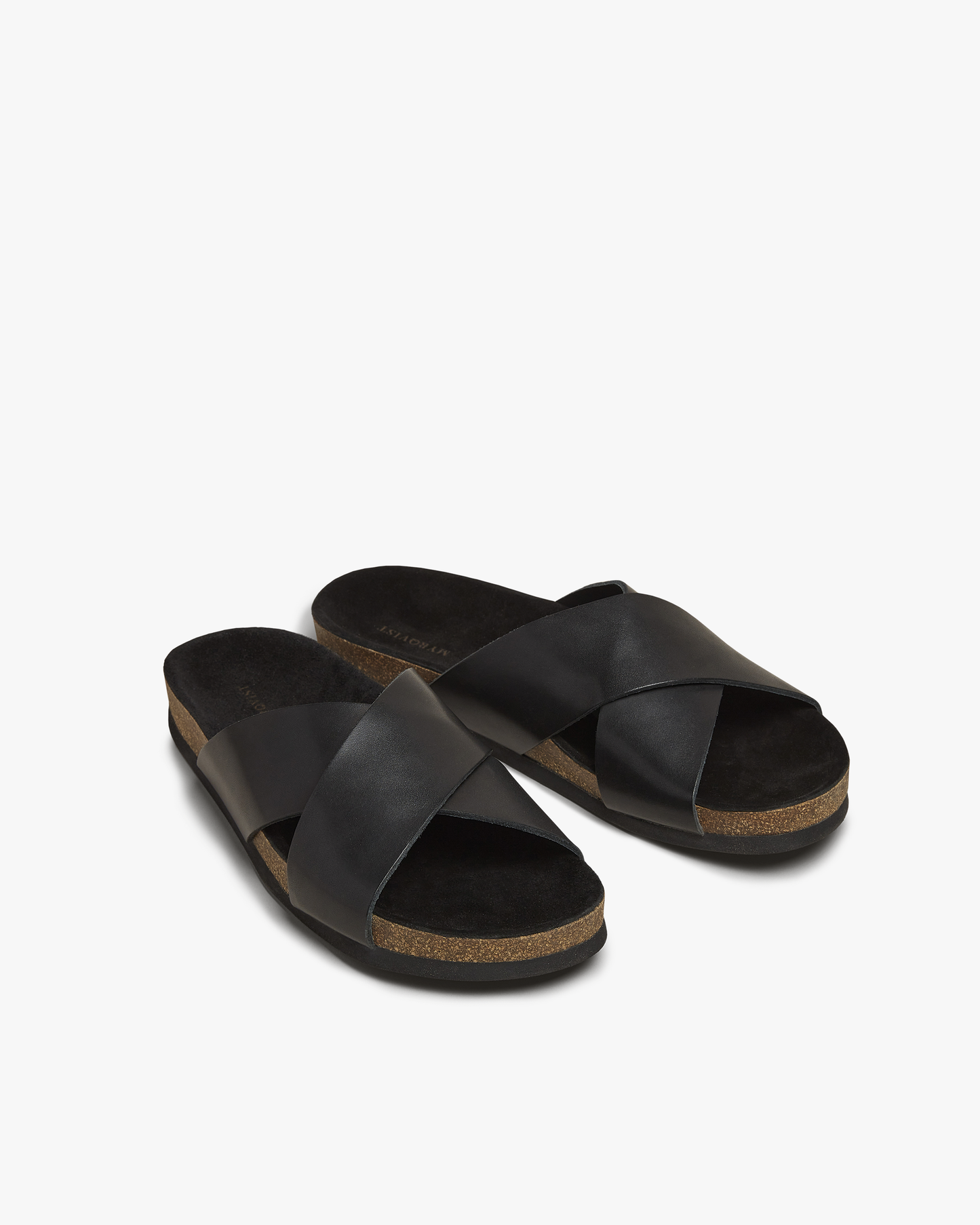 Solvik sandals in black calf with wide cross-over leather straps, a moulded cork footbed, and open toe design, offering a refined and versatile option for summer wear.