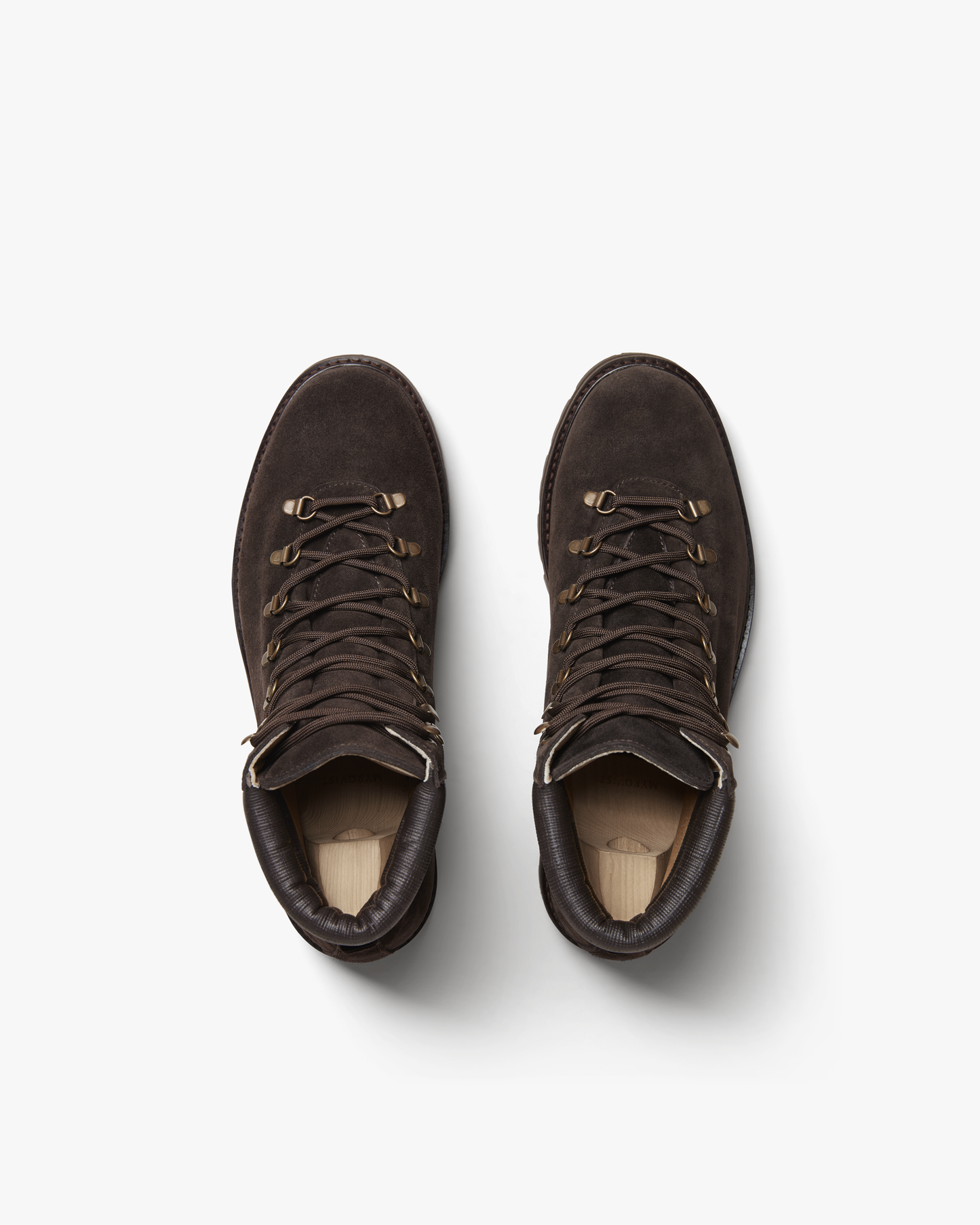 Duved in dark brown suede shown from above, highlighting the rich suede texture, brass-toned hardware, padded leather collars, and secure lacing system designed for comfort and support.
