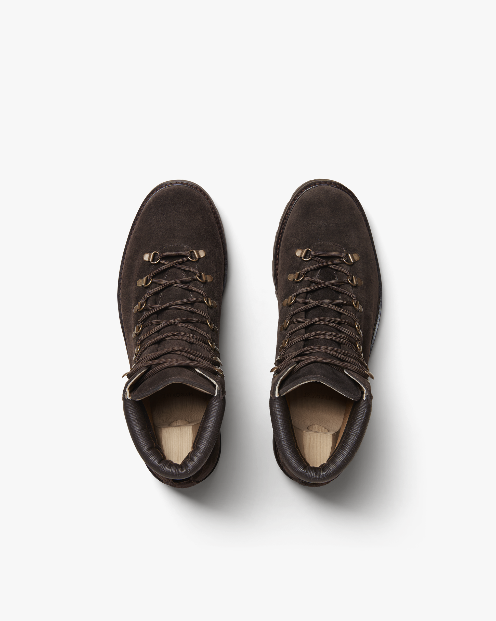 Duved in dark brown suede shown from above, highlighting the rich suede texture, brass-toned hardware, padded leather collars, and secure lacing system designed for comfort and support.