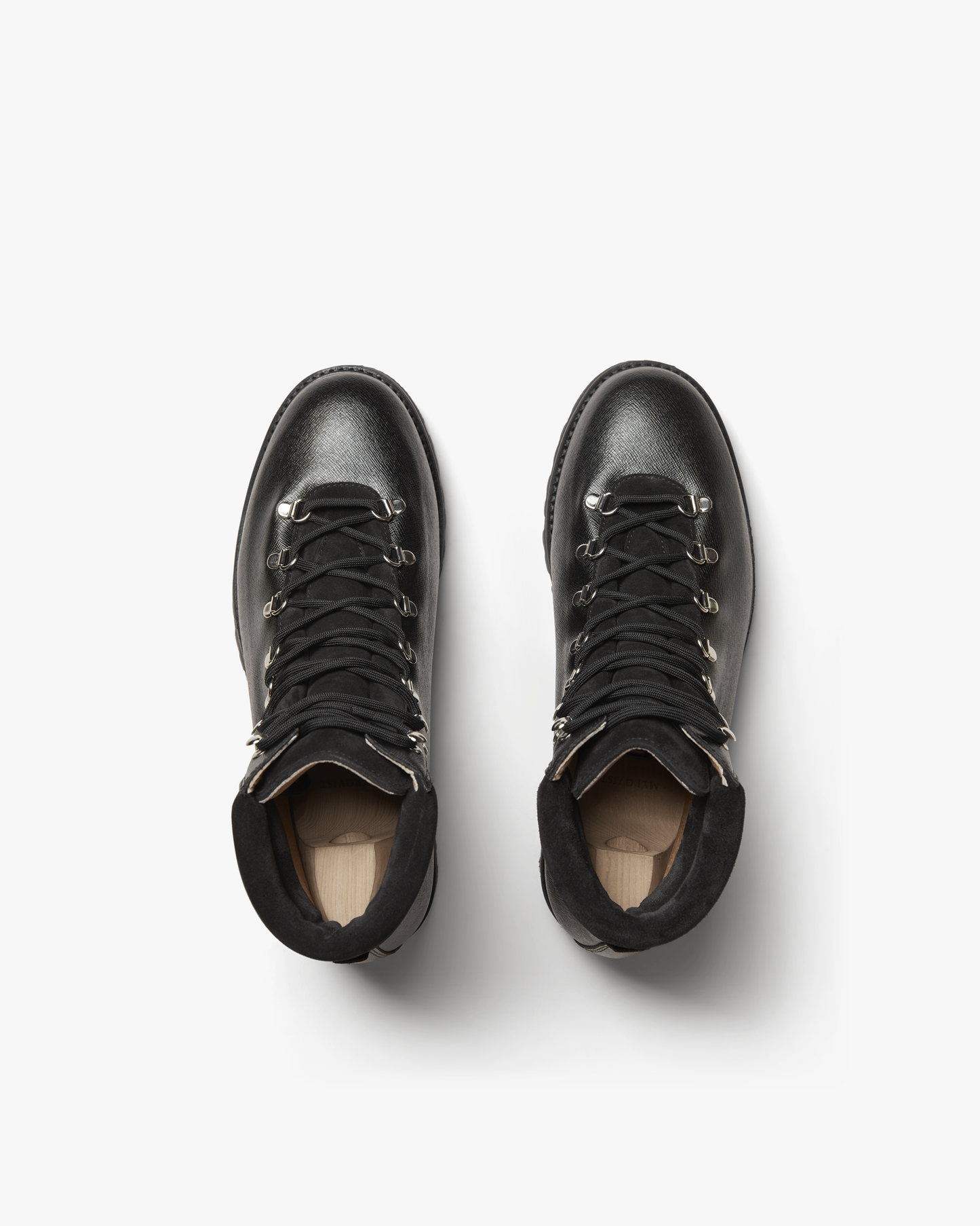 Duved in black grain calf shown from above, highlighting the textured leather, secure lacing system, padded collars, and silver-toned hardware for a refined hiking boot style.