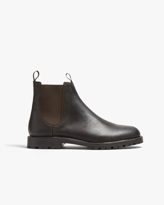 Chelsea boot in brown waxed suede with elastic side panels, pull tabs, and a sturdy commando sole, showcasing a matte finish and streamlined silhouette.