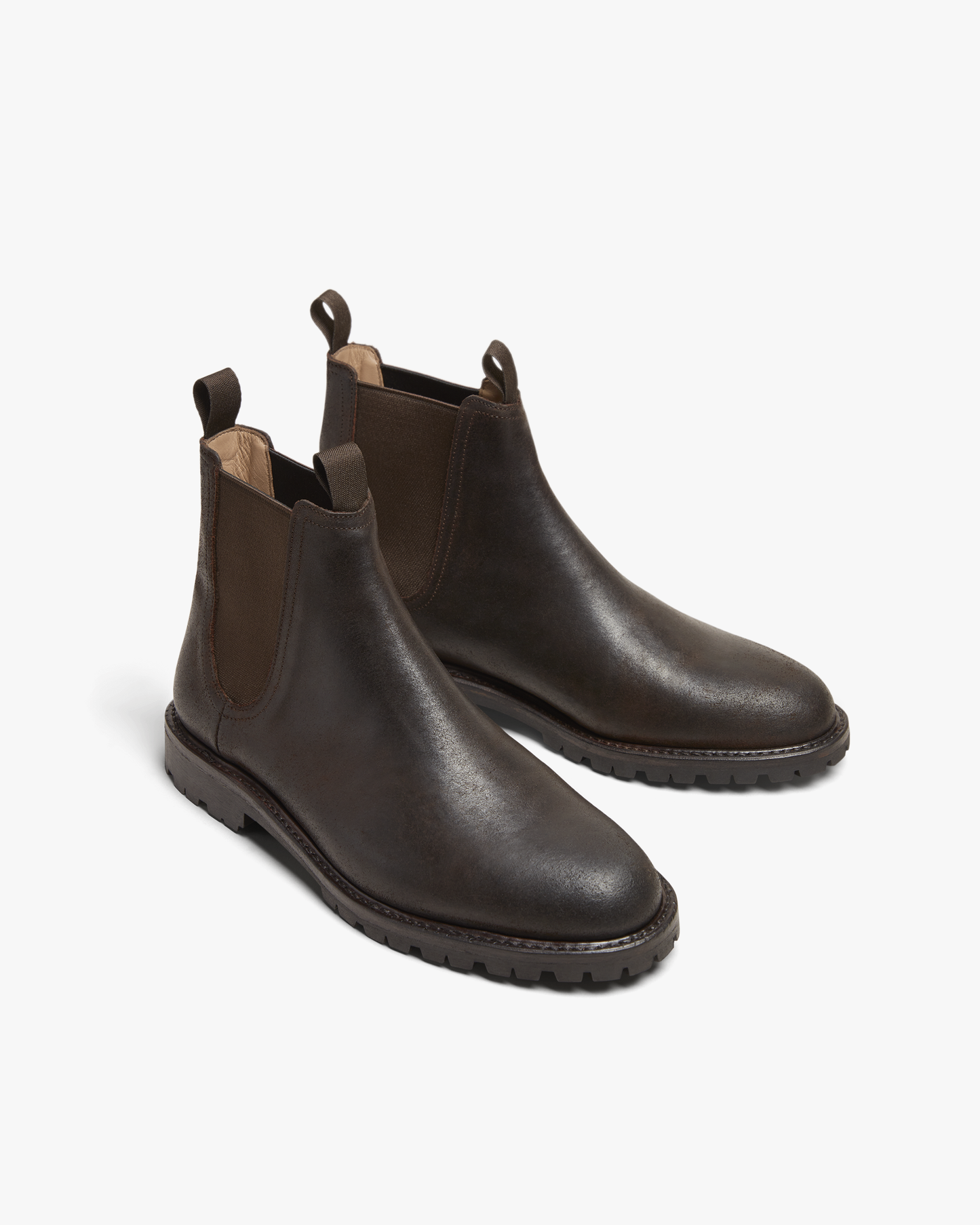Elfvik in brown waxed suede, featuring a matte finish, elastic side panels, pull tabs, and a rugged commando sole, designed as versatile Chelsea boots for men.