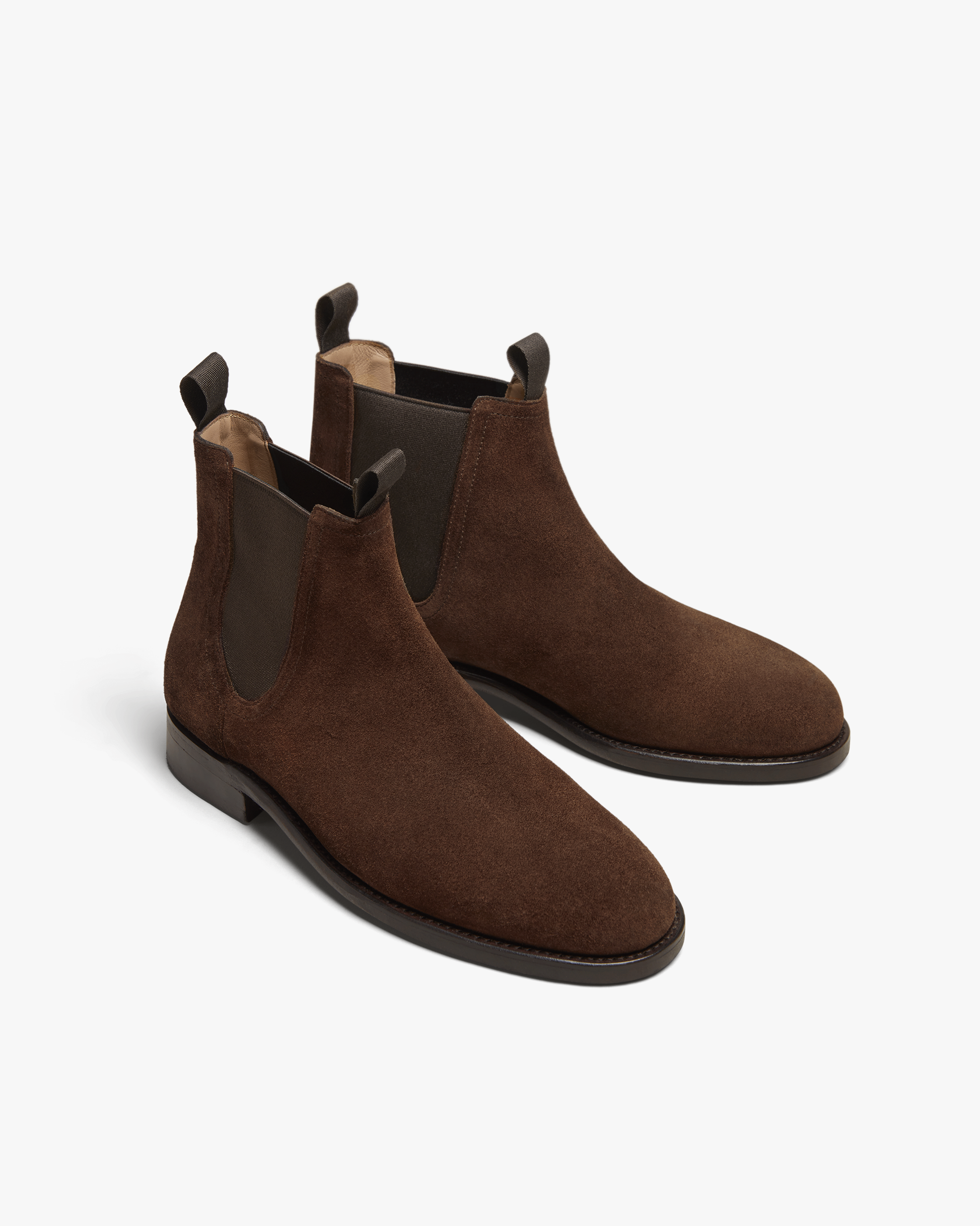 Elfvik Chelsea boots in dark brown suede feature a sleek, water-repellent suede upper, elastic side panels, and pull tabs, offering a refined silhouette ideal for pairing with slacks, trousers, or denim.