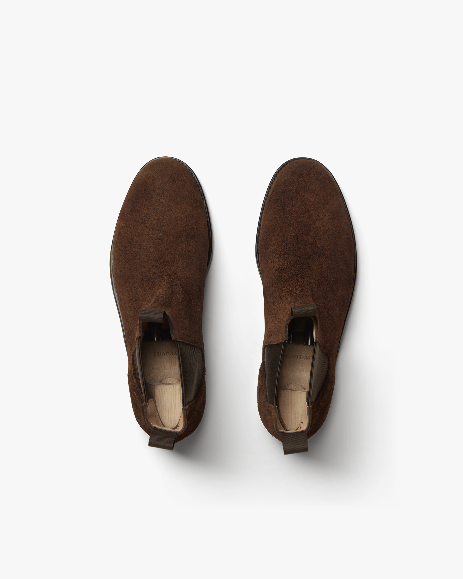 Elfvik Chelsea boots in dark brown suede shown from above, highlighting the smooth suede texture, pull tabs, and classic rounded toe design.