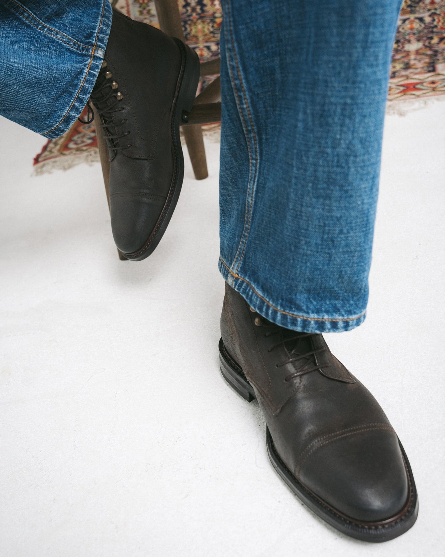 Abisko in brown waxed suede worn with denim jeans, highlighting the boot’s rounded toe, cap detail, and rugged lace-up design ideal for versatile winter style.