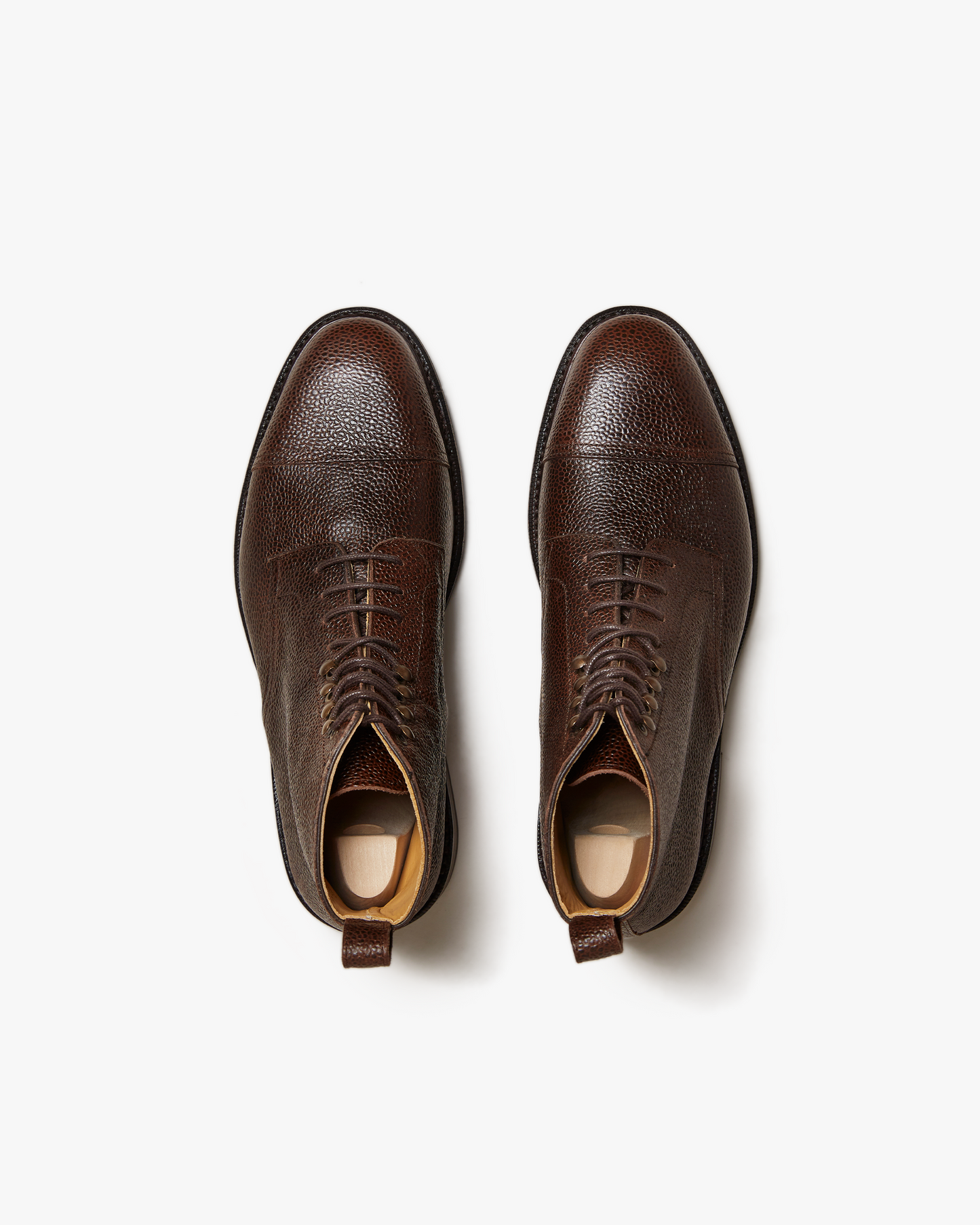 Abisko in dark brown country calf shown from above, highlighting the textured grained leather, cap toe design, and classic lace-up construction for a refined, versatile boot.