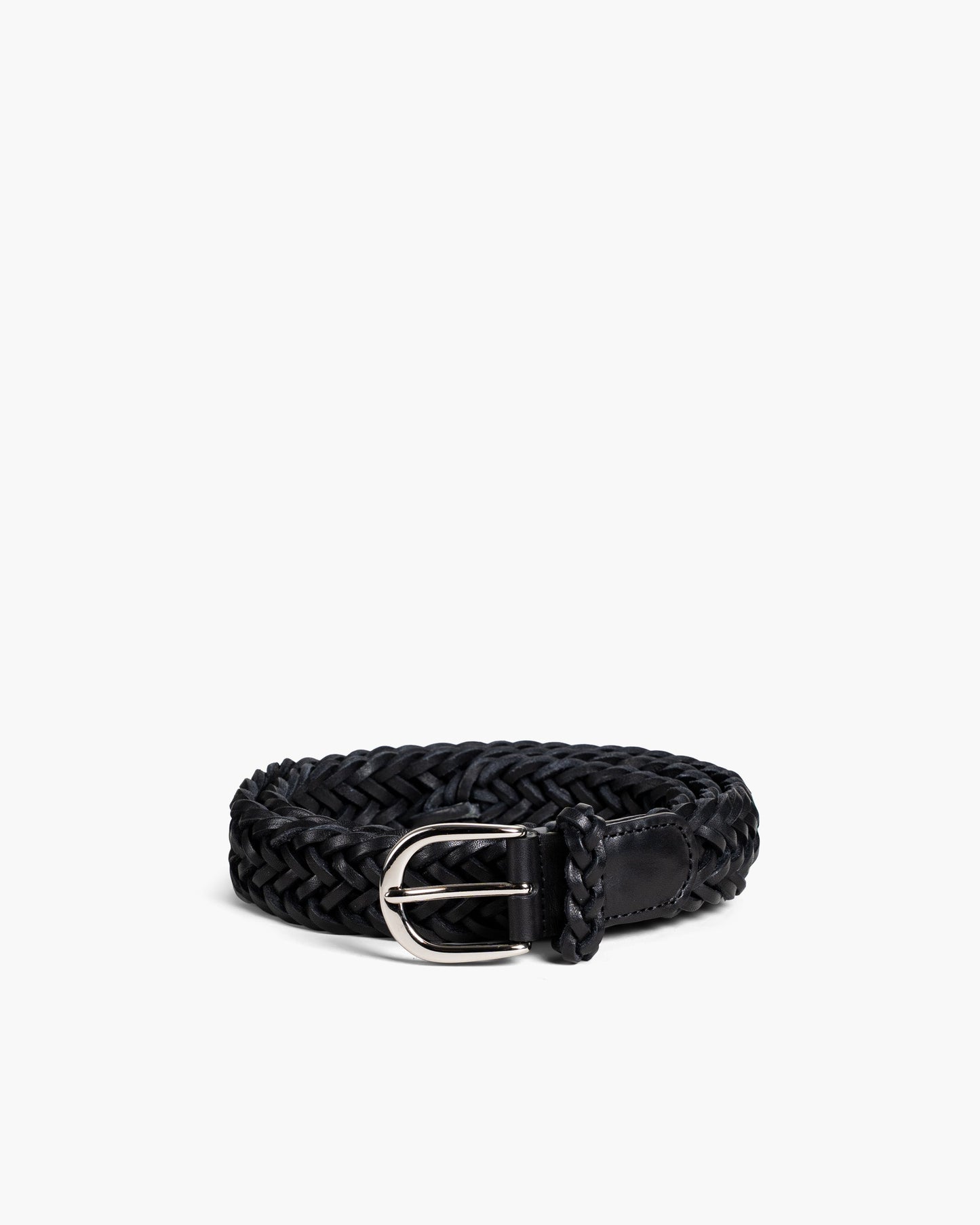 Braided Belt in black leather featuring a hand-woven design, polished silver-toned buckle, and supple texture, styled in a coiled position to highlight its craftsmanship and adjustable fit.