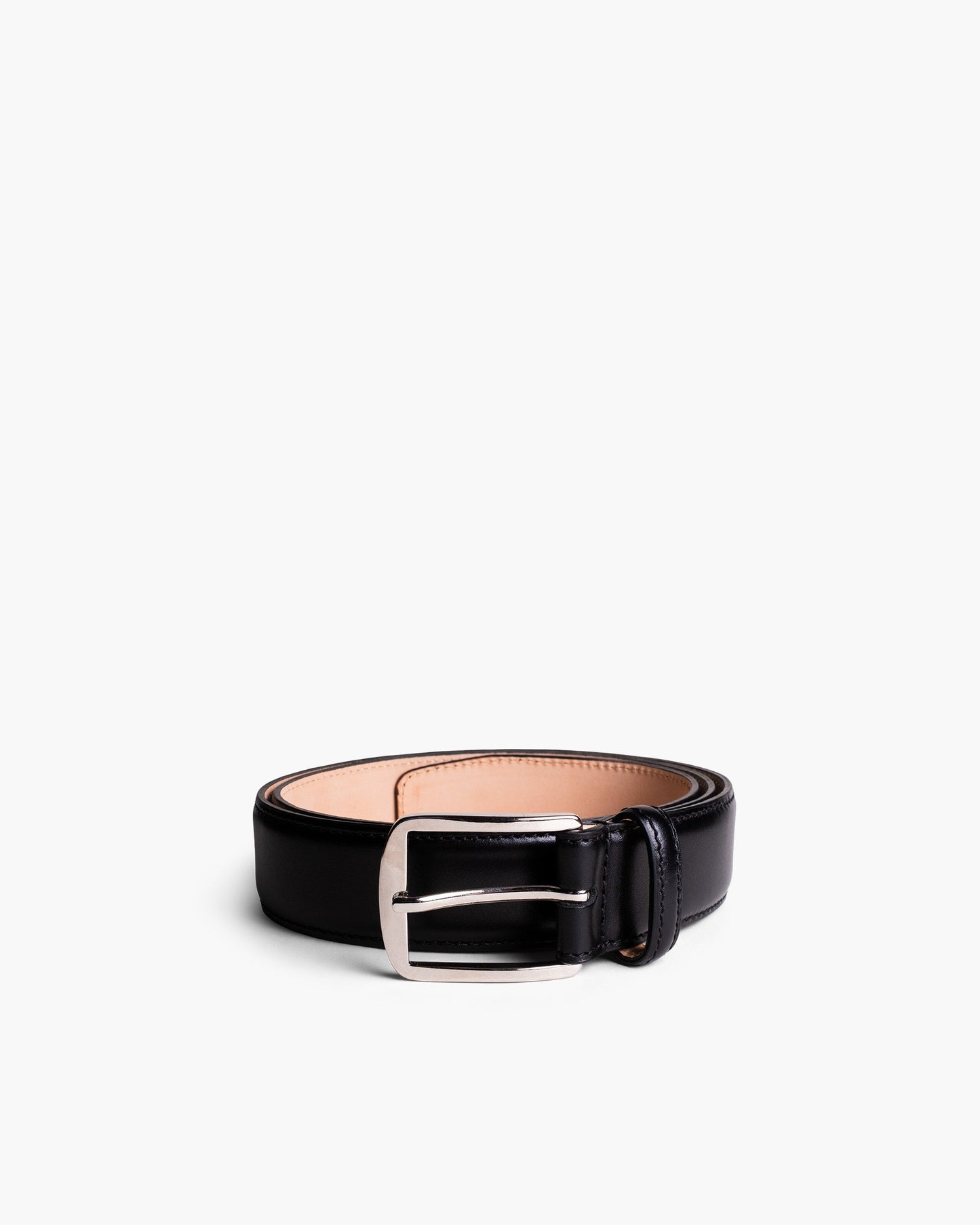 Black leather belt with a square silver buckle, featuring smooth polished leather and refined stitching, ideal for pairing with tailored trousers, slacks, or dark denim.