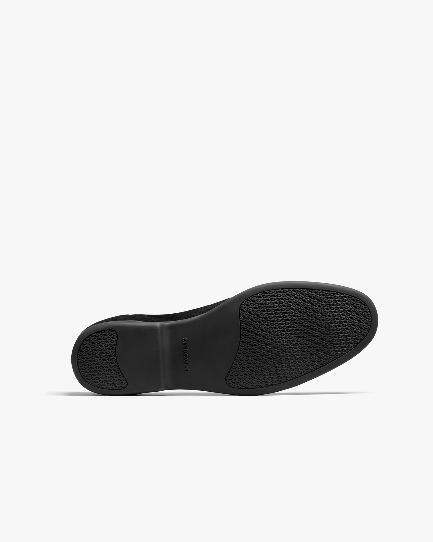 Close-up of the Brännö II in black suede showing the textured black rubber sole with subtle grip patterns and the Myrqvist logo embossed at the arch.
