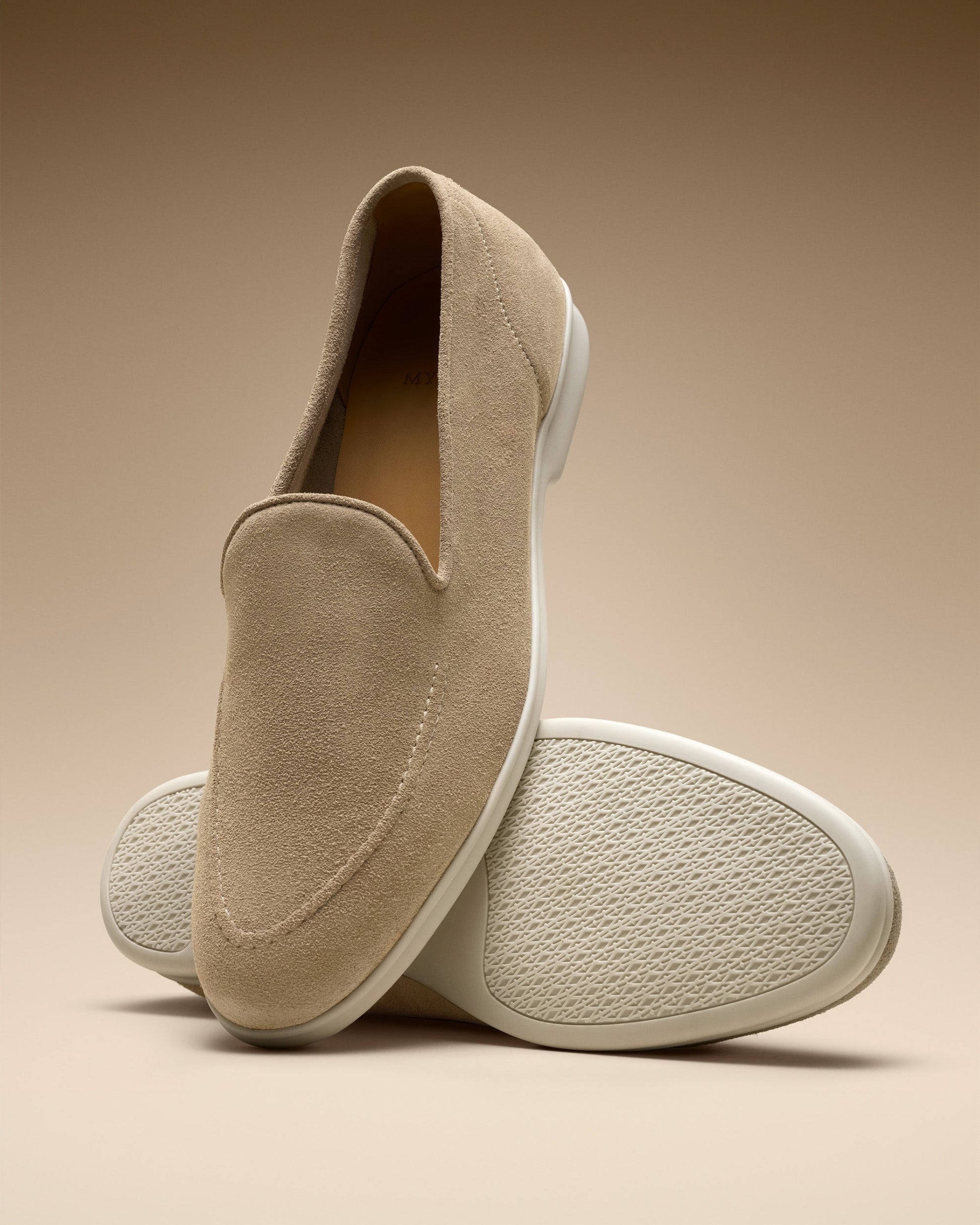 Brännö II in sand suede features a minimalist beige suede loafer with clean stitching and a white textured rubber sole, styled against a warm neutral background to highlight its refined design and versatility.