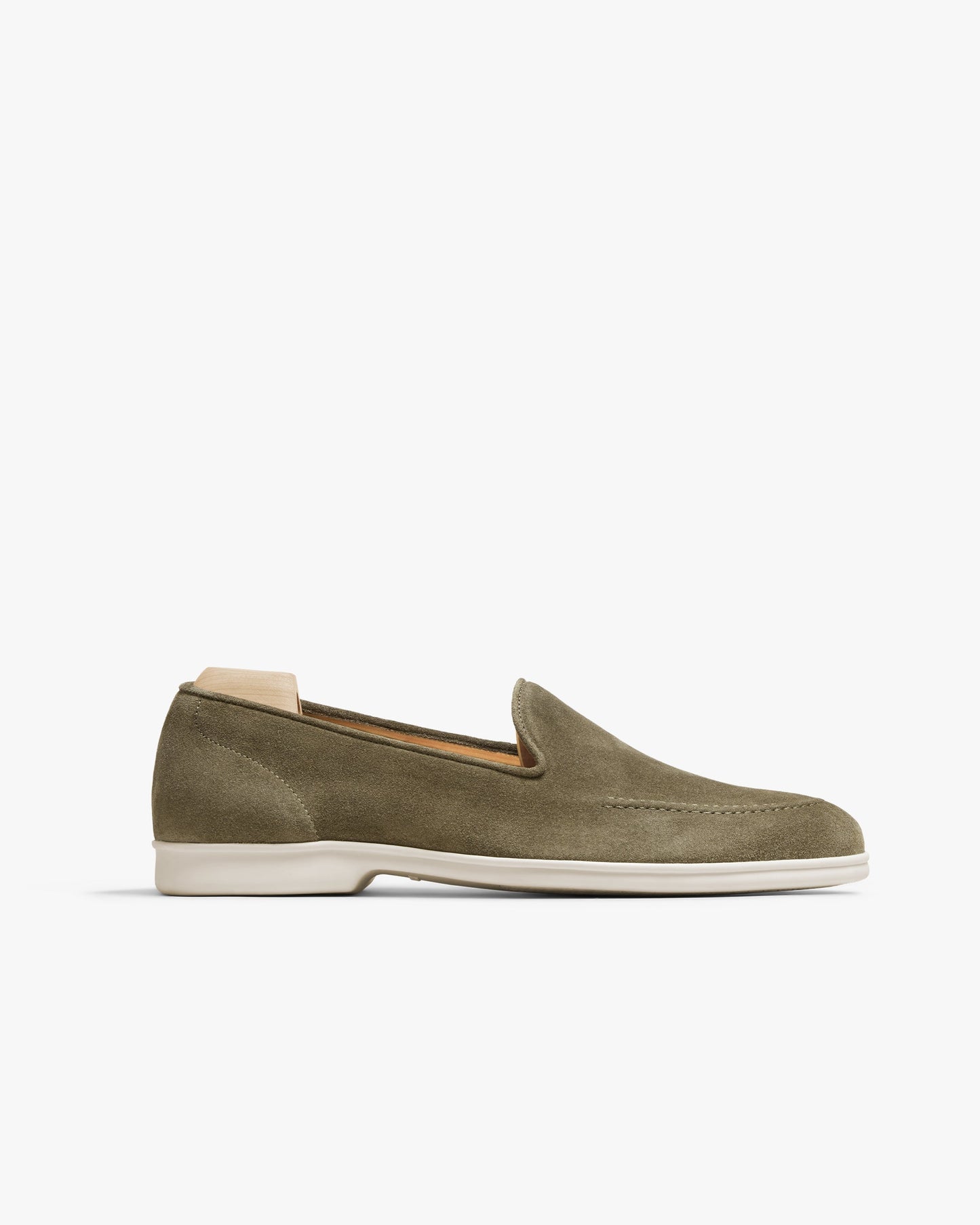 Brännö II in moss green suede features a minimalist loafer silhouette with clean lines, tonal stitching, and a crisp white rubber sole, offering a refined and contemporary look ideal for pairing with summer slacks or suits.