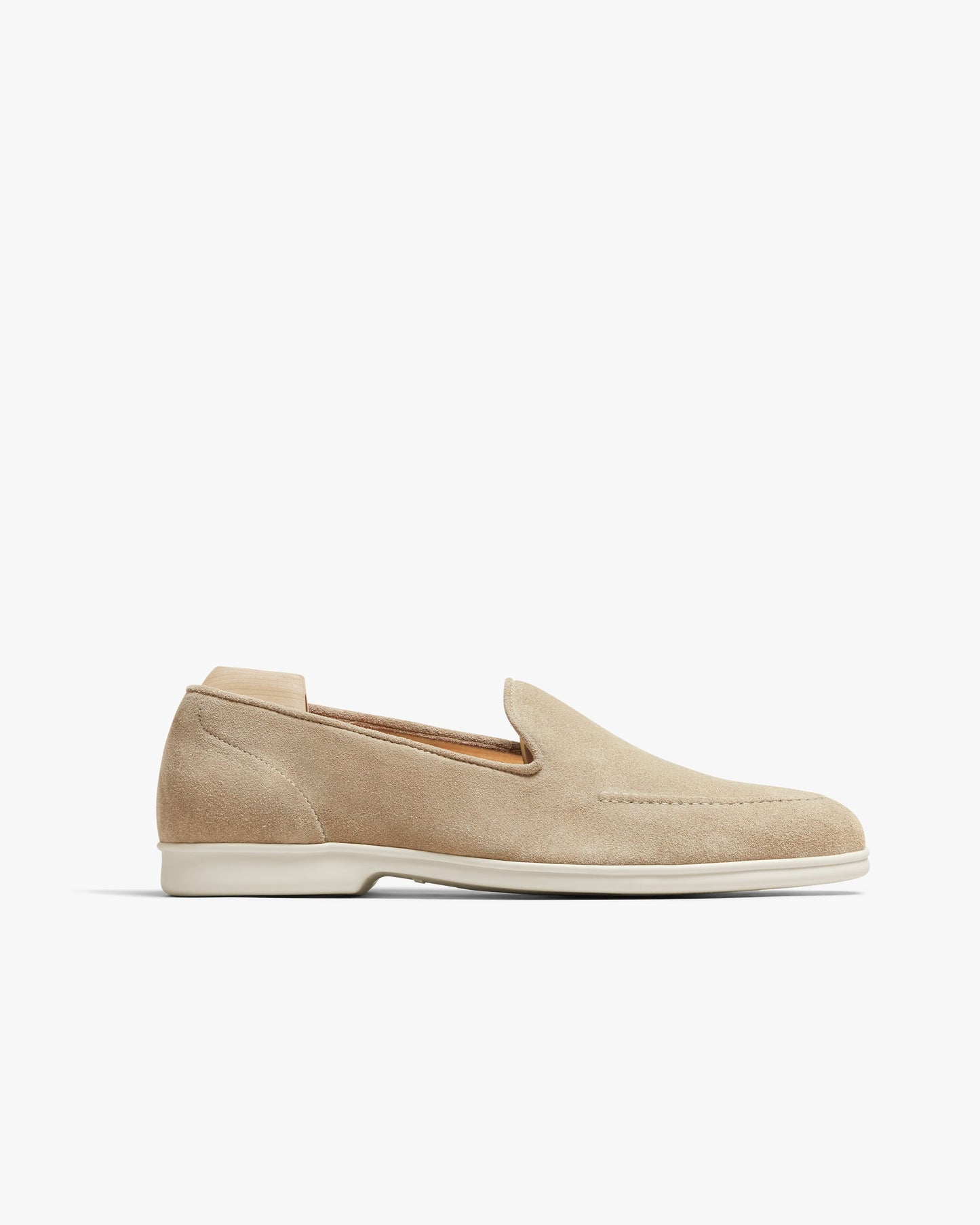 Brännö II in sand suede features a minimalist loafer silhouette with a soft beige suede upper, clean stitching, and a white rubber sole, offering a refined and versatile option for warm-weather dressing.