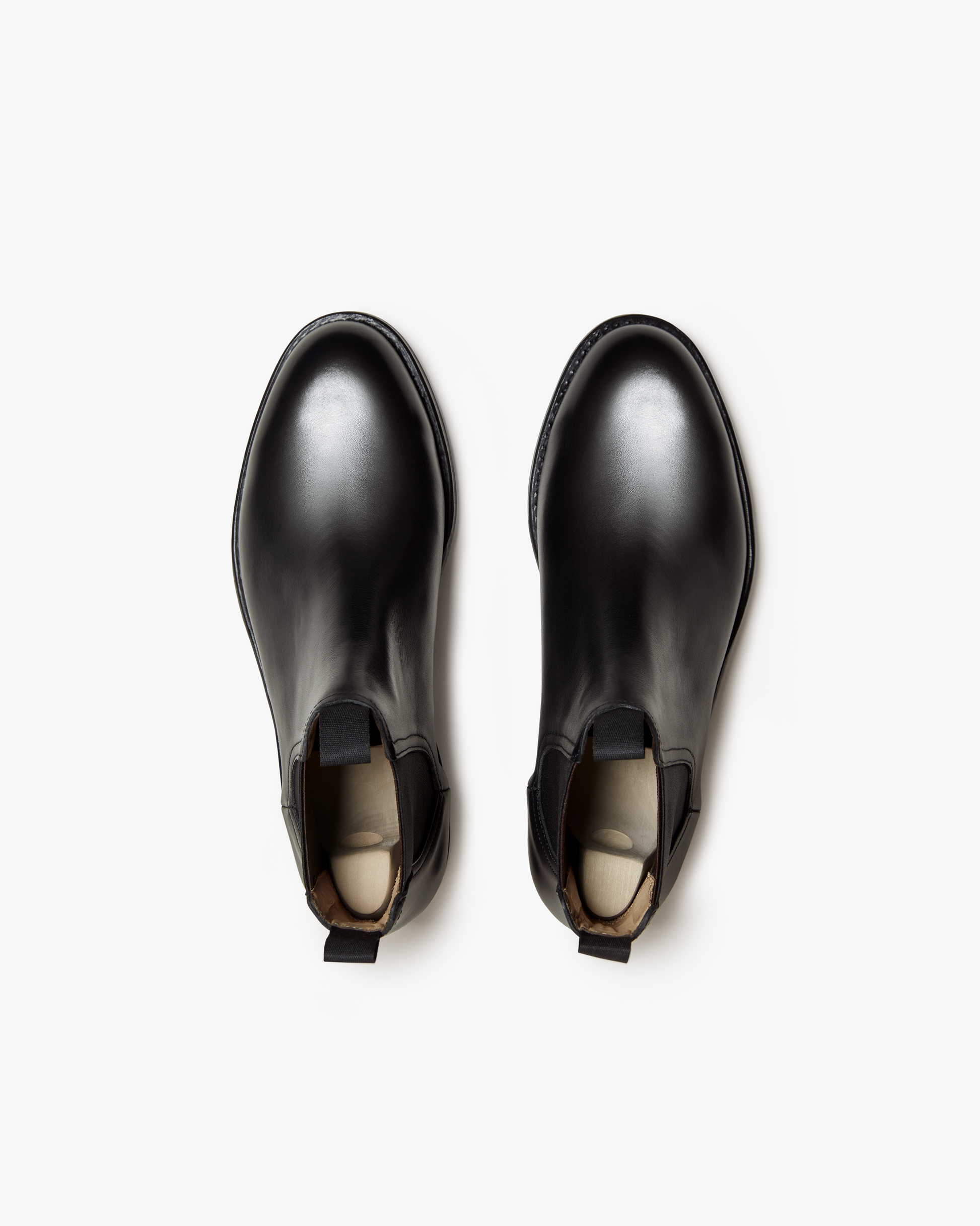 Top view of Elfvik Chelsea boots in black calf leather, showcasing the smooth rounded toes, elastic side panels, and twin pull tabs for easy entry.