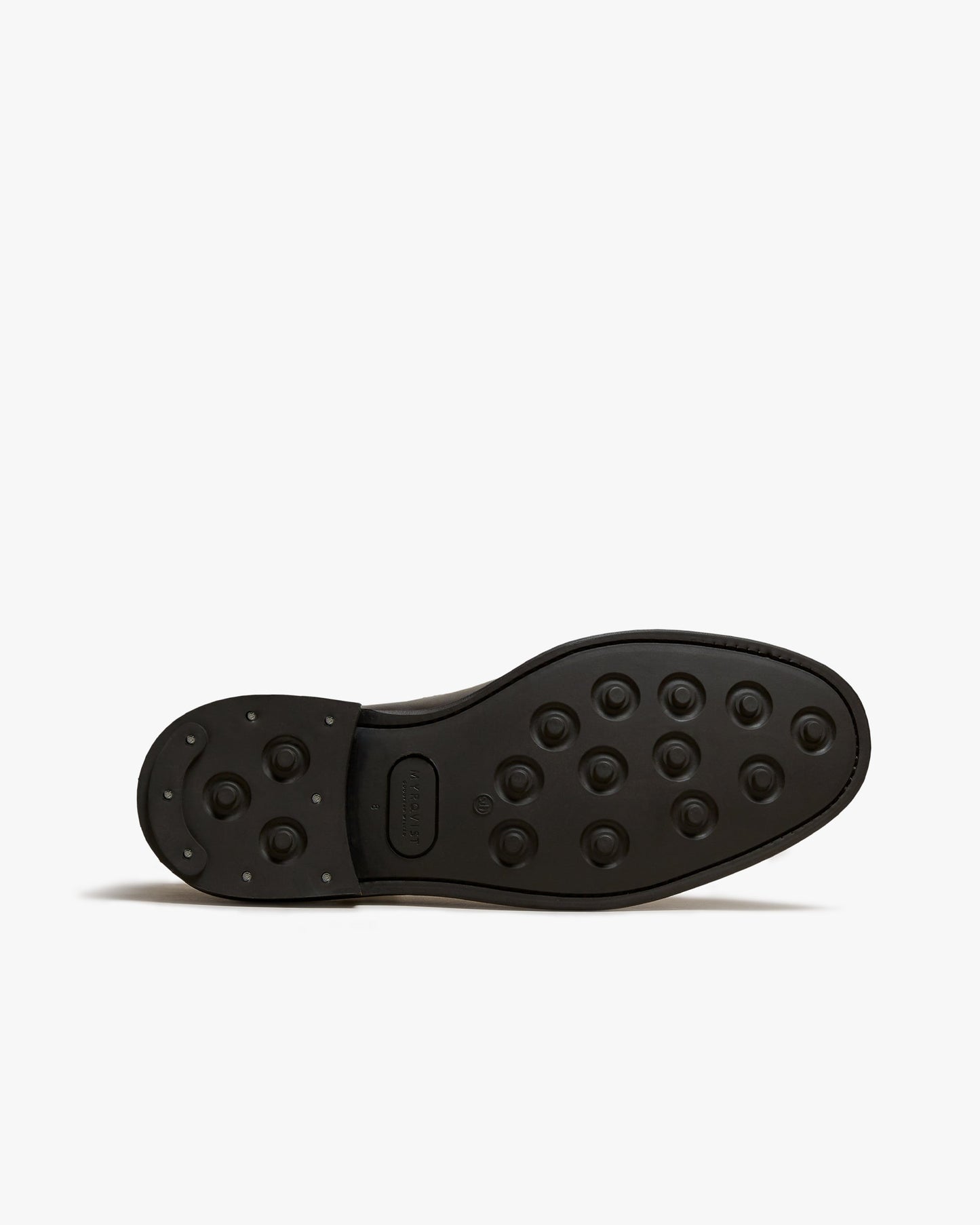 Close-up of the studded rubber sole on Elfvik Chelsea boots in dark brown suede, showing the durable tread pattern designed for reliable traction on city streets or rural paths.