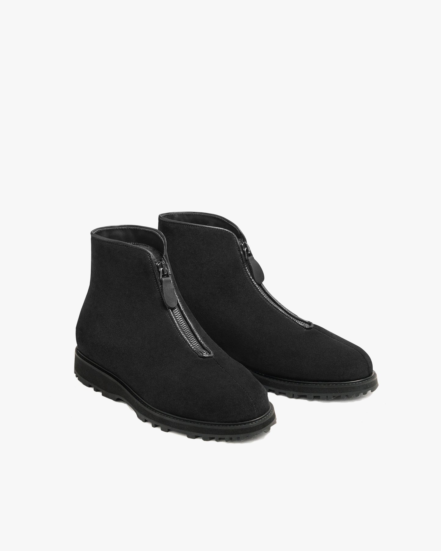 Funäs in black suede features a pair of minimalist ankle boots with a central zipper, water-repellent suede upper, and a rugged Explorer sole, designed for versatile winter wear.