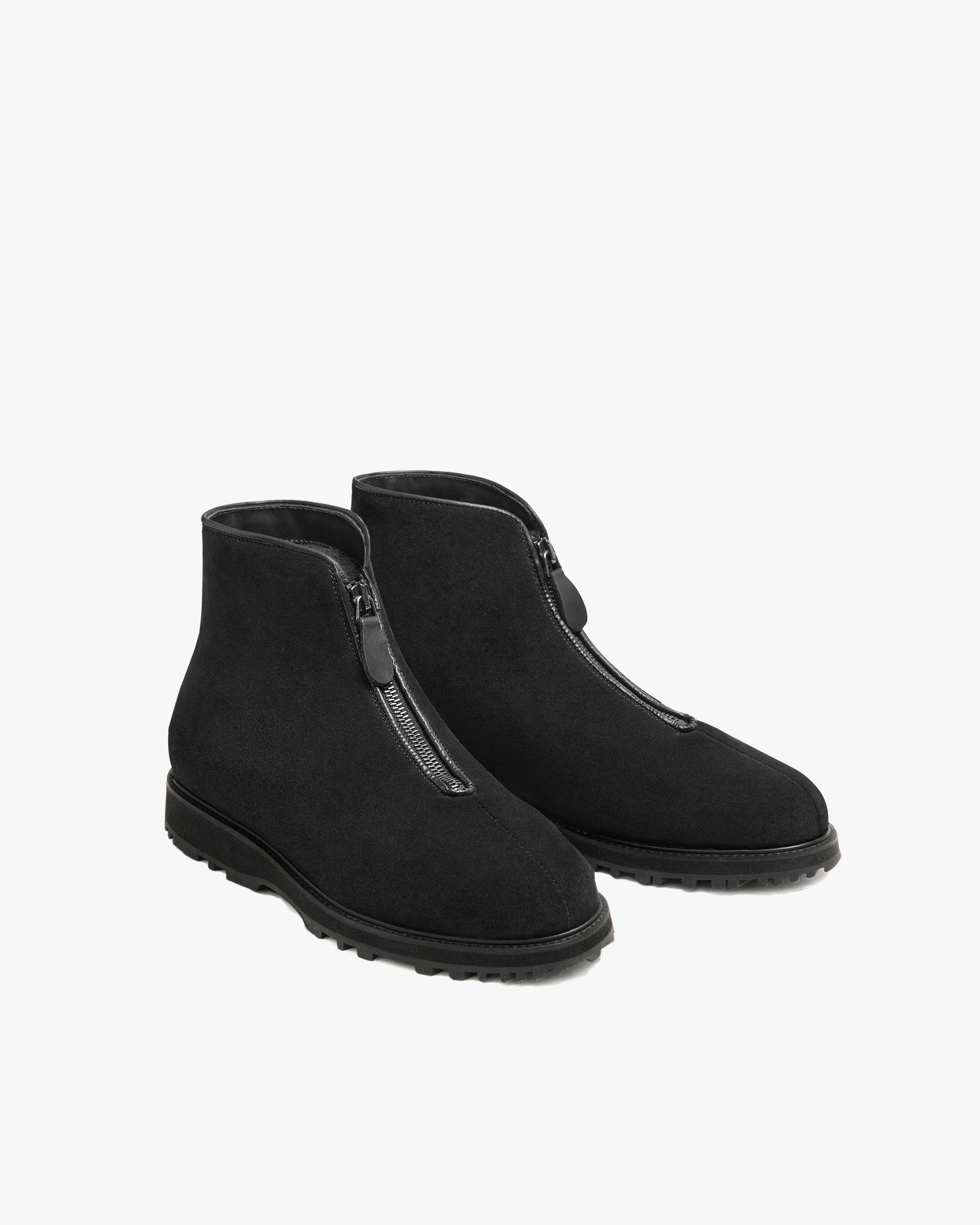 Funäs in black suede features a pair of minimalist ankle boots with a central zipper, water-repellent suede upper, and a rugged Explorer sole, designed for versatile winter wear.