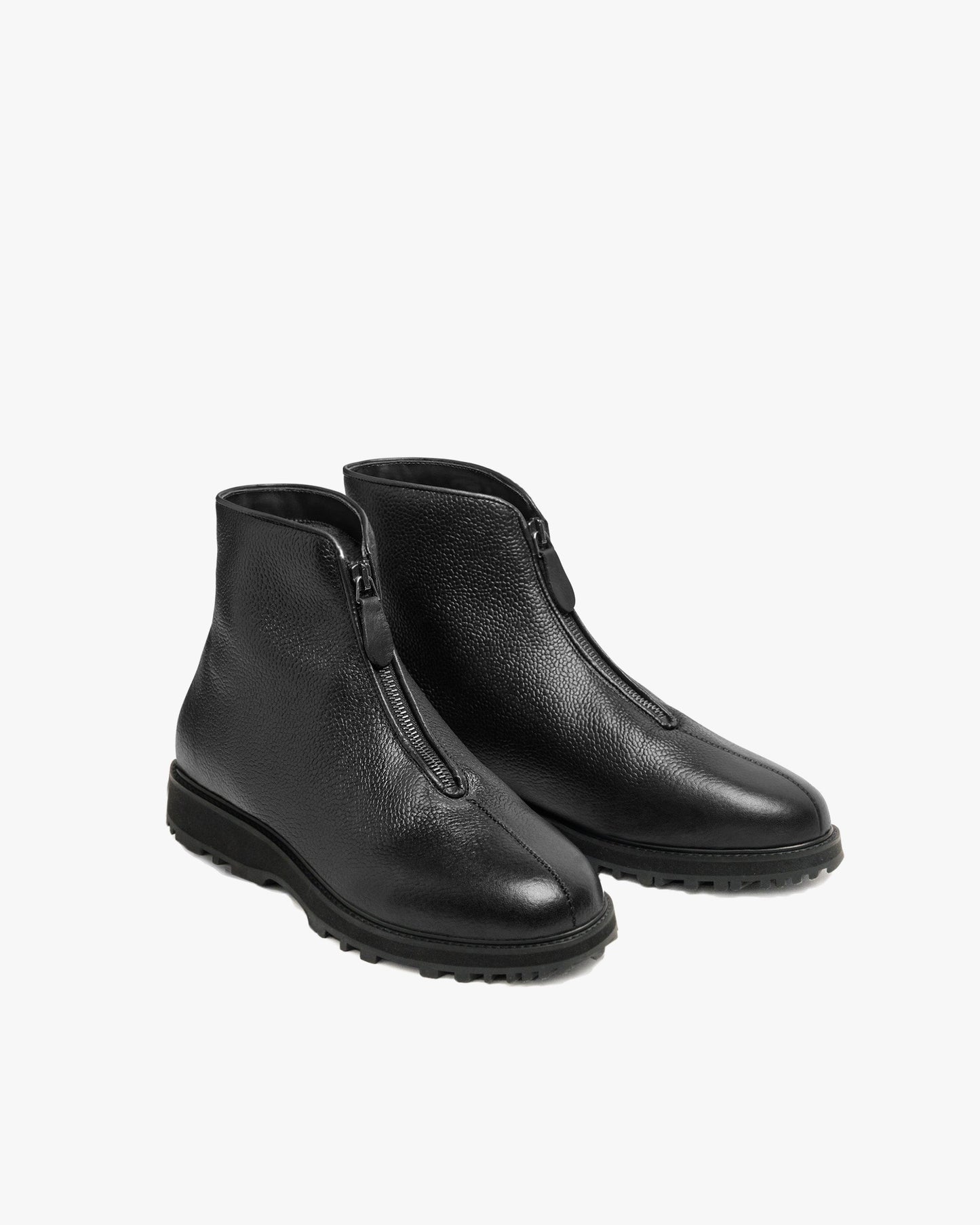 Funäs in black country calf features a pair of minimalist ankle boots with textured full-grain leather, central zippers, and sturdy Explorer soles, designed for both formal and casual winter wear.