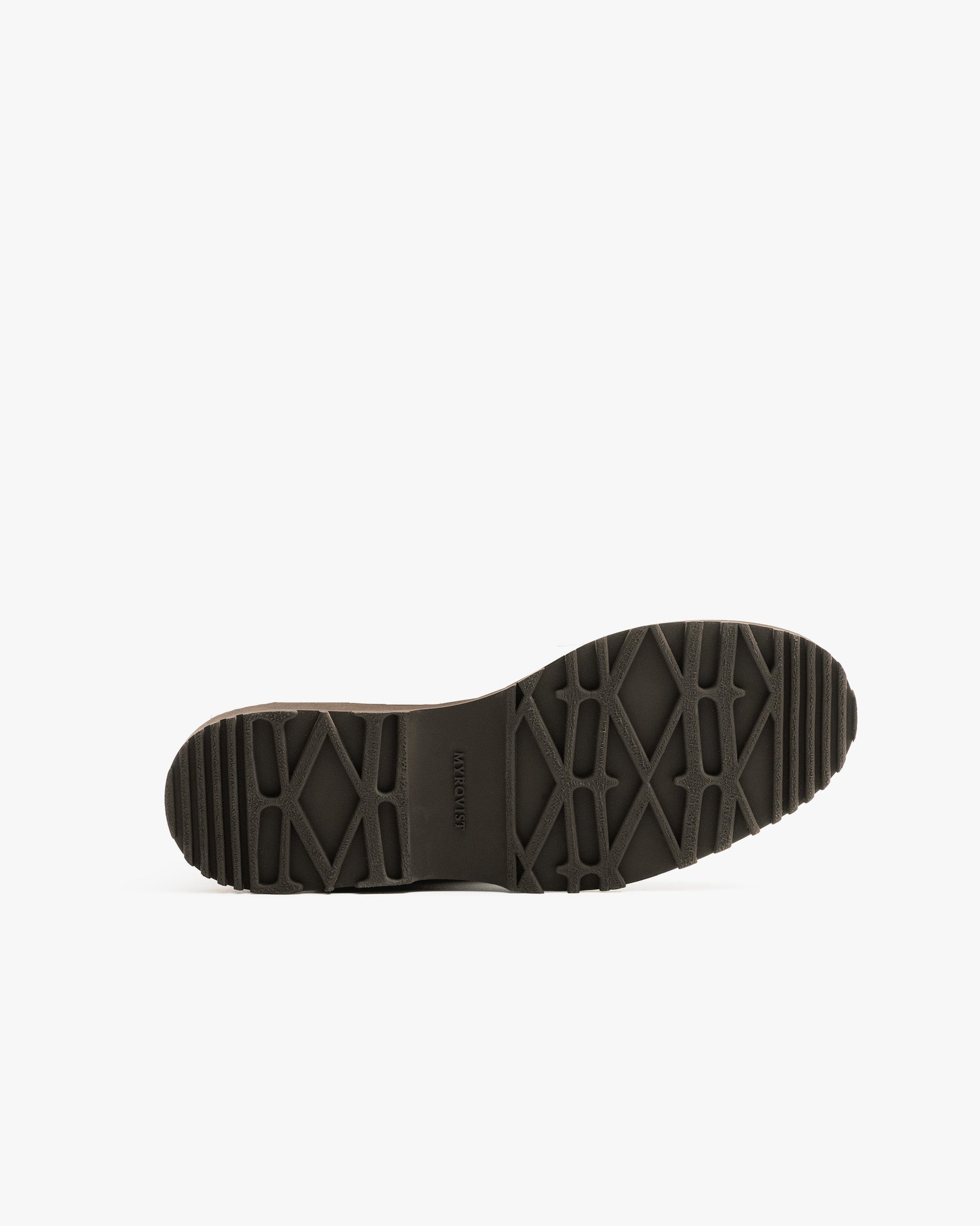 Close-up of the Explorer sole on Funäs in dark brown country calf, highlighting the rugged tread pattern designed for reliable grip and stability in winter conditions.