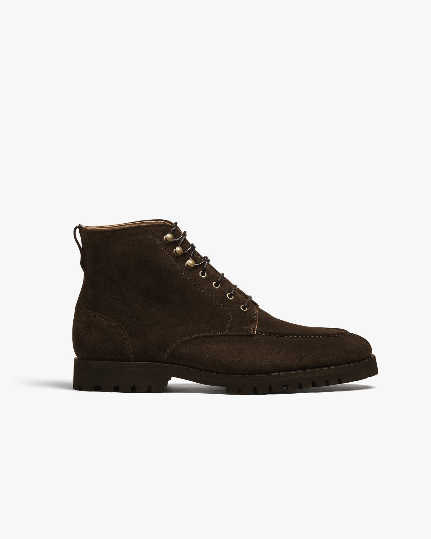 Gothem II in dark brown suede features a classic split toe apron, sturdy lug sole, and speed hooks, blending refined suede texture with rugged outdoor-ready design. This men's boot is shown in profile, highlighting its deep brown hue and precise stitching.