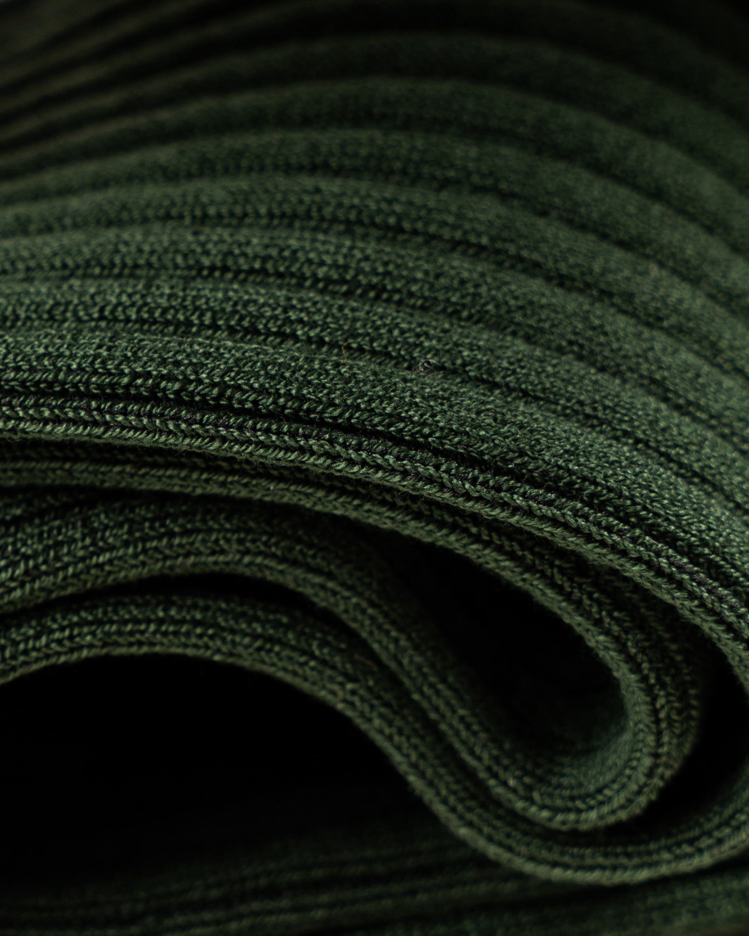 A detailed close-up of Nils – Knee-High Cotton Socks – Dark Green, highlighting the fine ribbed texture of the fabric.
