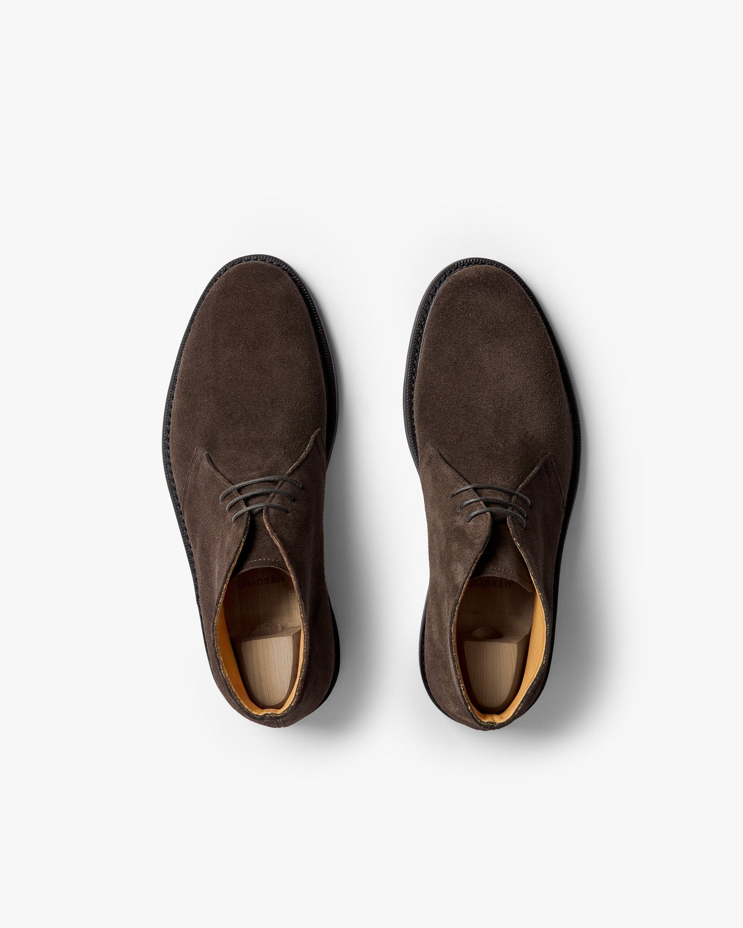 Pair of Gyllsjö II chukka boots in dark brown suede shown from above, featuring clean lines, soft suede texture, and a softly chiseled toe with understated stitching and leather lining.