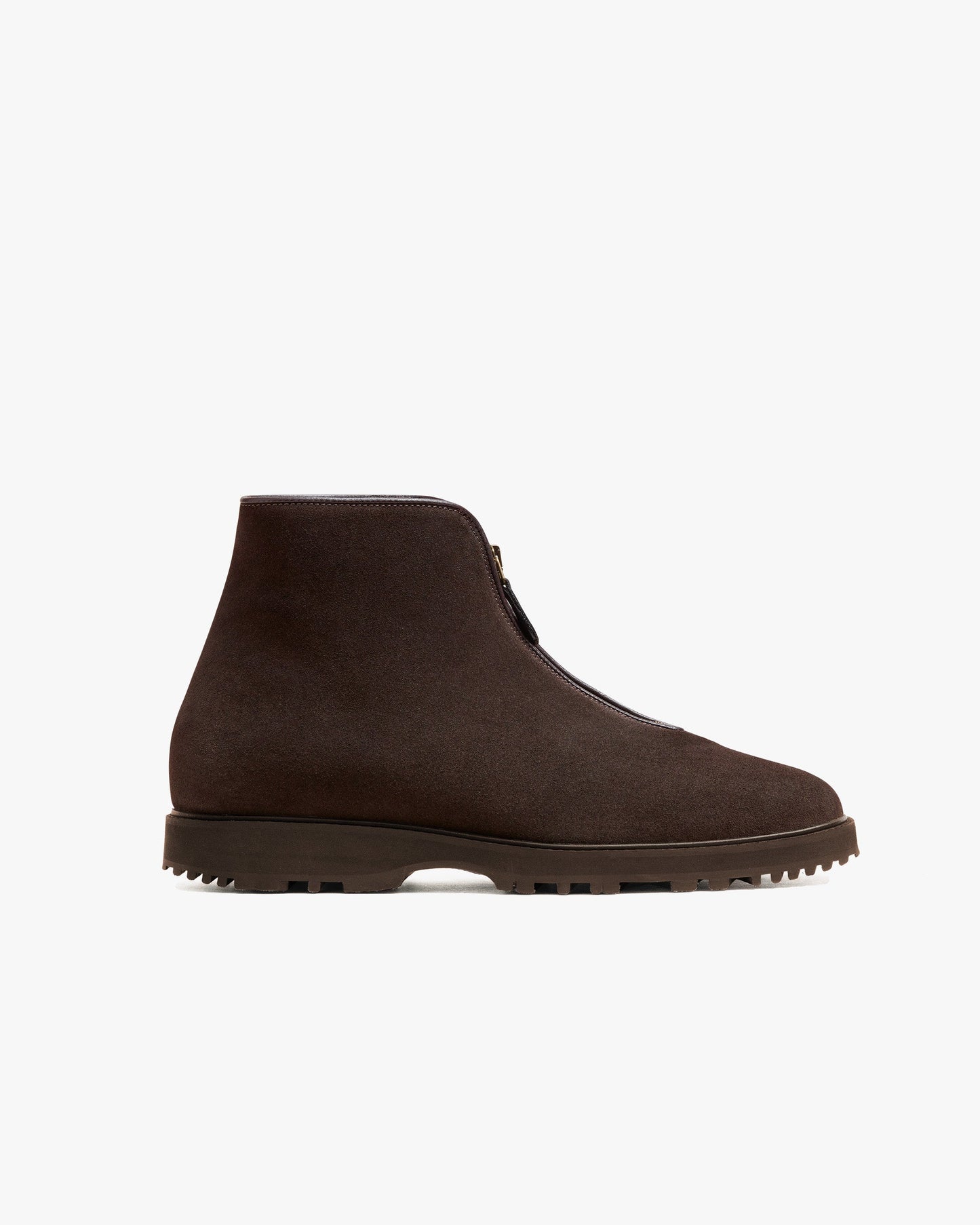 Funäs in dark brown suede features a minimalist ankle boot silhouette with a central zipper and rugged Explorer sole, crafted in water-repellent suede for versatile winter wear. The deep brown tone and clean lines offer understated sophistication, ideal for pairing with wool trousers, slacks, or denim.