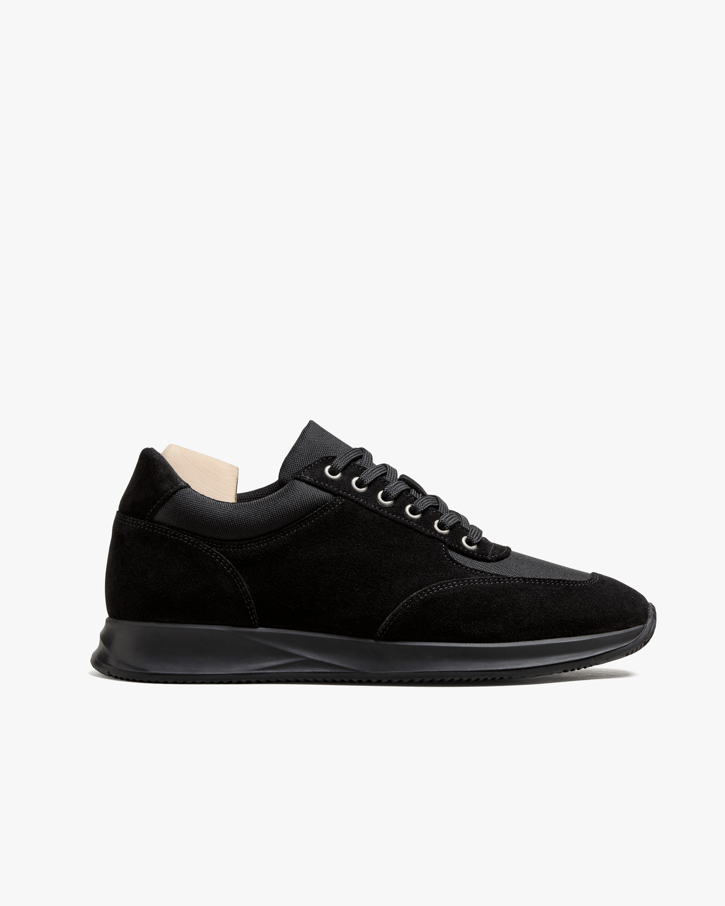Stensund in black suede features a sleek low-top silhouette with tonal mesh panels, matching laces, and a streamlined black rubber sole, showcasing refined Scandinavian design and versatile styling for both smart and casual looks.