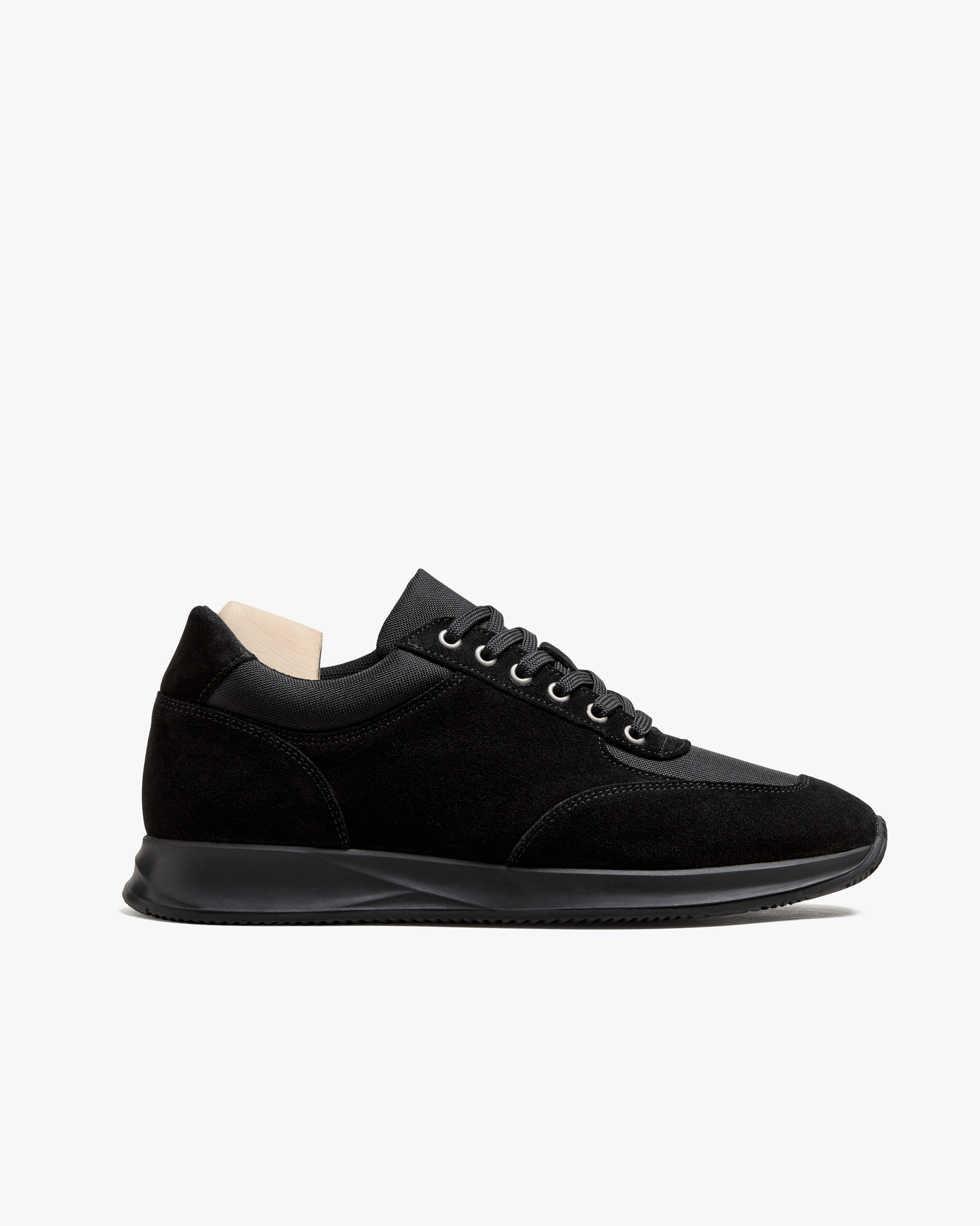Stensund in black suede features a sleek low-top silhouette with tonal mesh panels, matching laces, and a streamlined black rubber sole, showcasing refined Scandinavian design and versatile styling for both smart and casual looks.