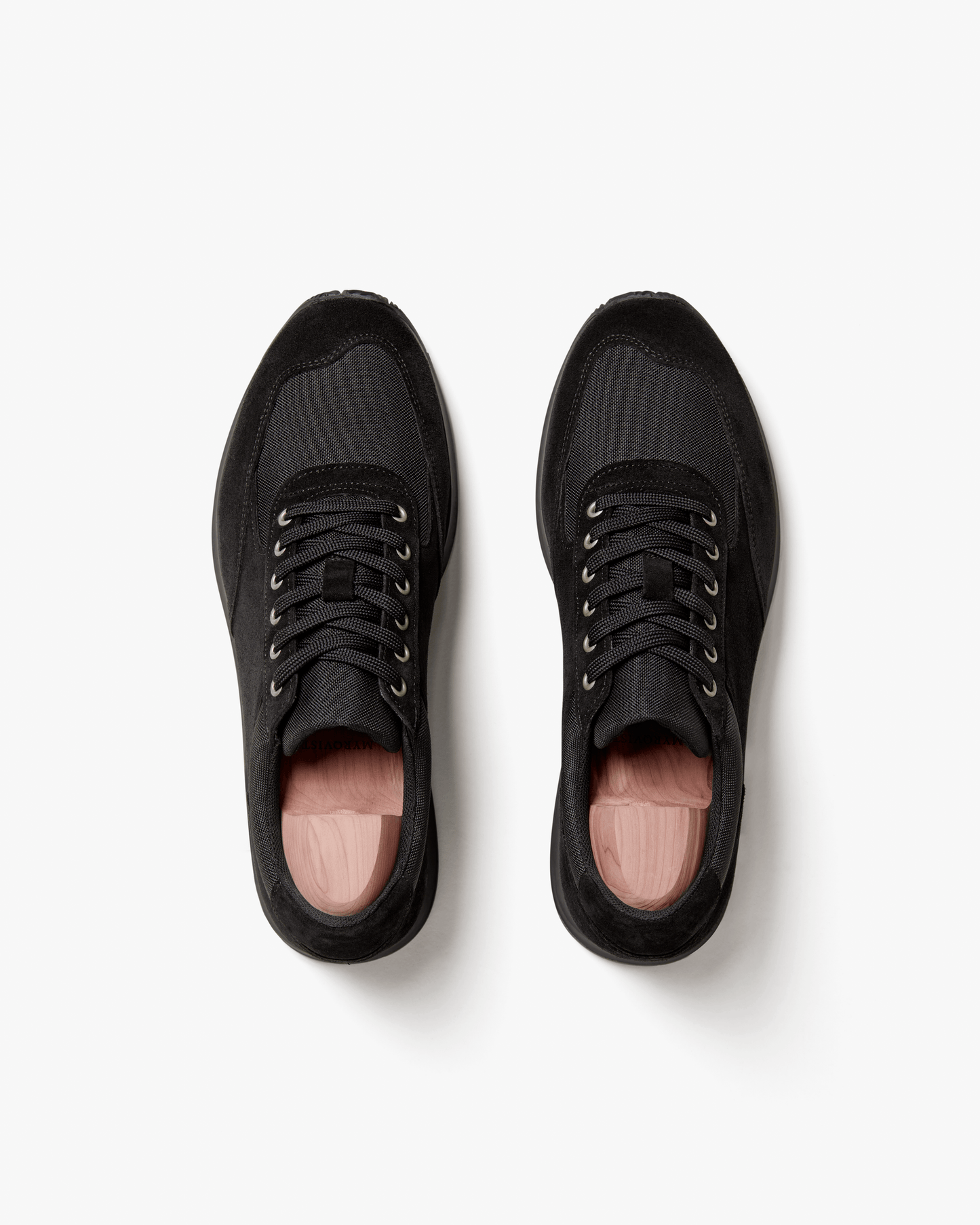 Stensund in black suede shown from above, highlighting the clean silhouette, tonal mesh panels, lace-up closure, and subtle stitching that define this versatile black trainer.