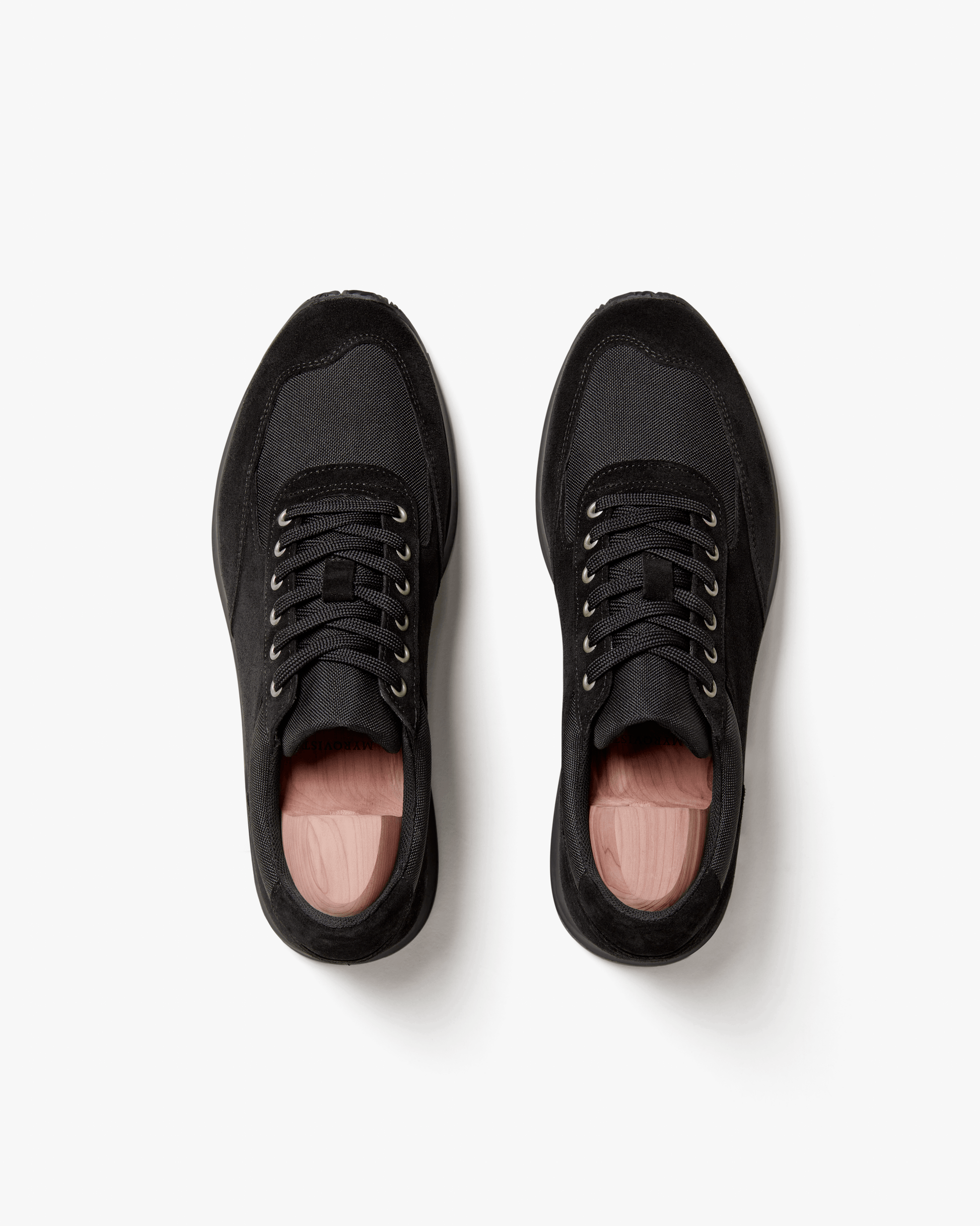 Stensund in black suede shown from above, highlighting the clean silhouette, tonal mesh panels, lace-up closure, and subtle stitching that define this versatile black trainer.