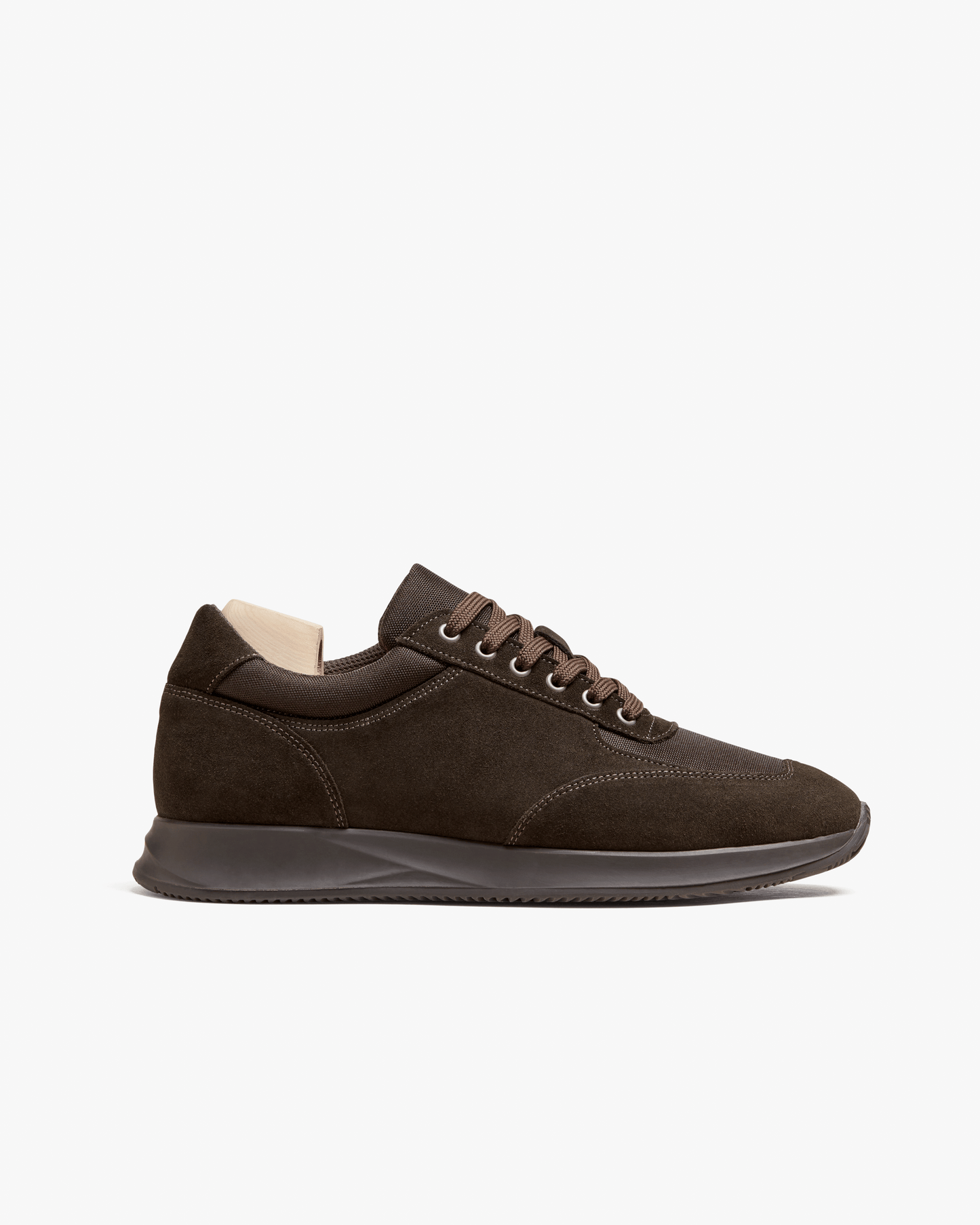 Stensund in dark brown suede features a low-profile silhouette with tonal mesh panels, matching laces, and a sculpted rubber sole, showcasing a refined and versatile sneaker ideal for both casual and business casual looks.