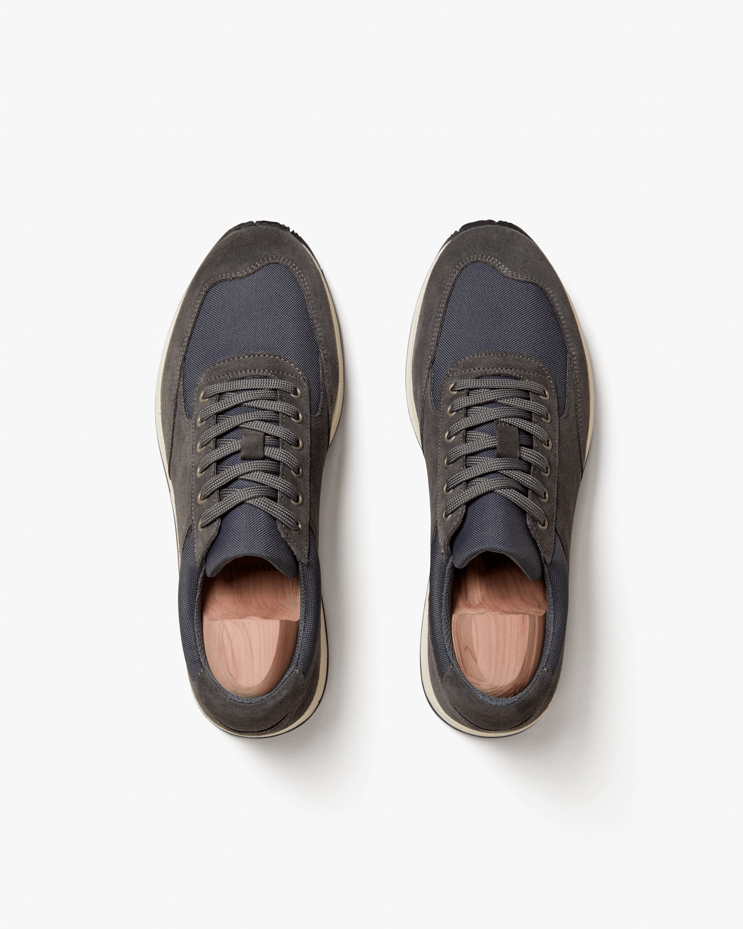 Stensund in dark grey suede shown from above, highlighting the tonal mesh panels, lace-up design, and softly contoured silhouette with contrasting off-white soles.