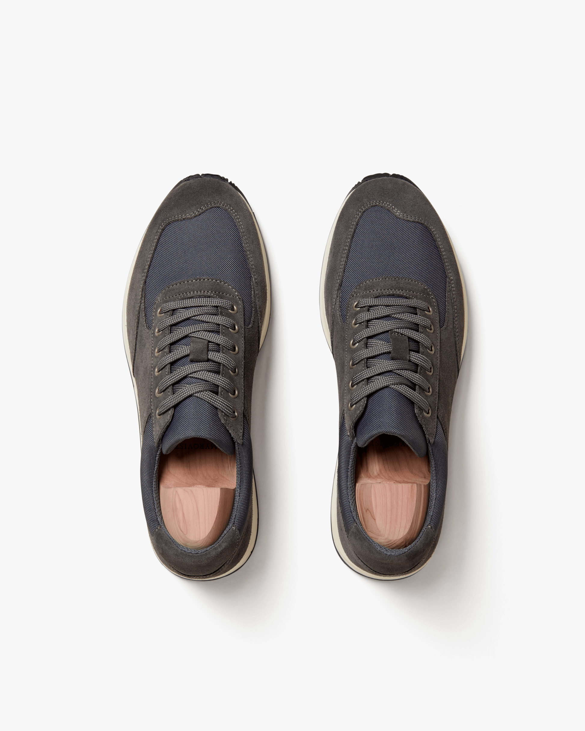 Stensund in dark grey suede shown from above, highlighting the tonal mesh panels, lace-up design, and softly contoured silhouette with contrasting off-white soles.