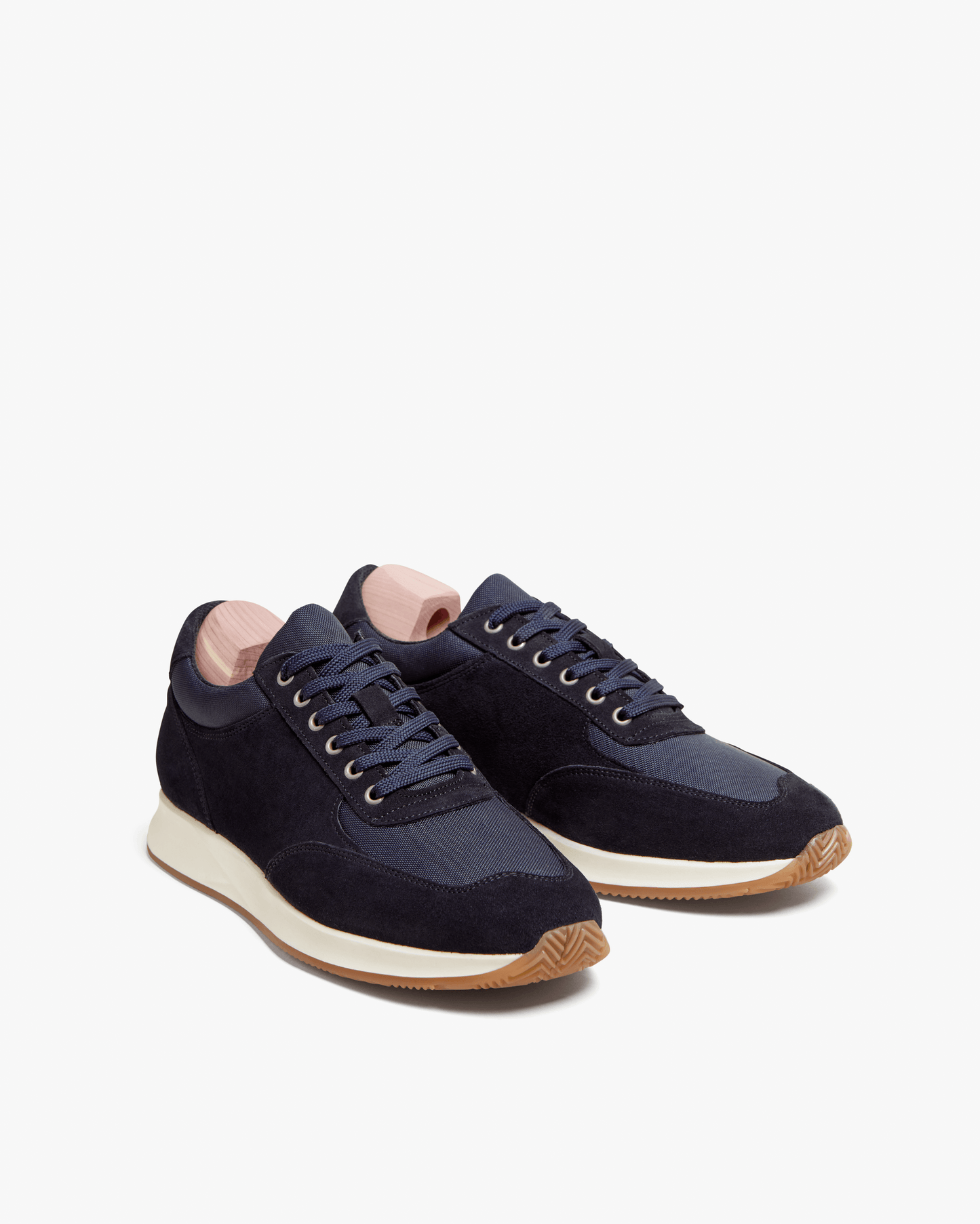 Stensund in navy suede displayed at a three-quarter angle, featuring deep navy suede and mesh panels, navy laces, and a natural-toned rubber sole with gum detailing, highlighting its refined Scandinavian design and versatile style.