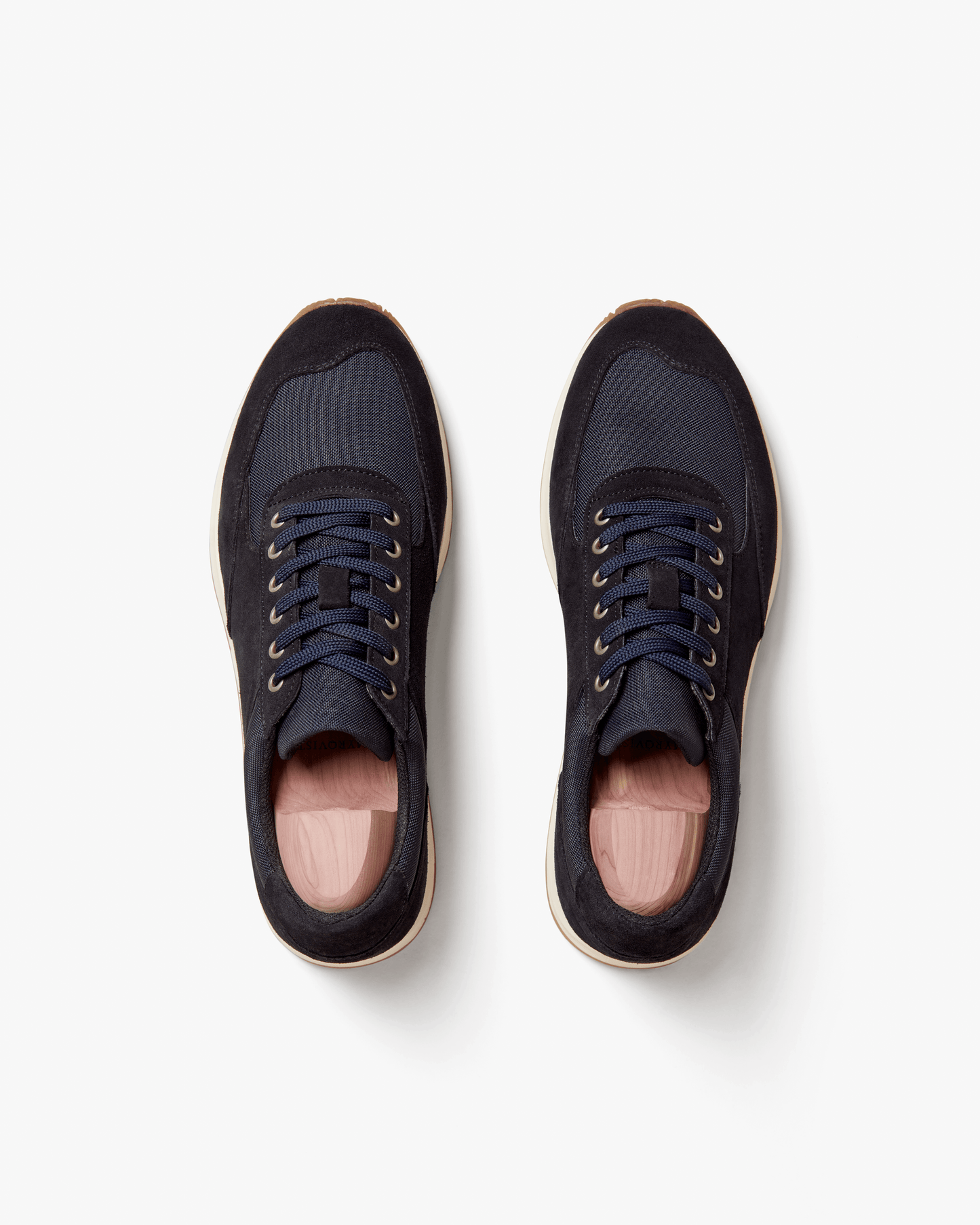 Stensund in navy suede shown from above, highlighting the deep navy suede and tonal mesh panels, lace-up closure, and natural-toned rubber sole with gum detailing. The clean, athletic silhouette and subtle color palette emphasize its versatility for both tailored trousers and denim.