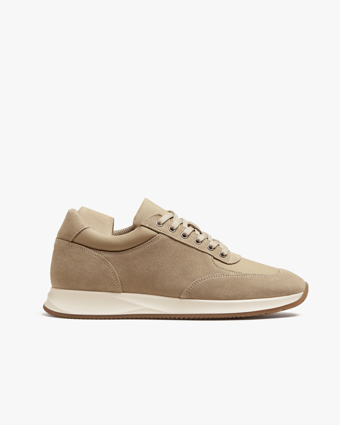 Stensund in sand suede features a minimalist trainer silhouette with soft beige suede, tonal mesh panels, and a lightweight rubber sole, offering a refined look ideal for both tailored slacks and casual outfits.