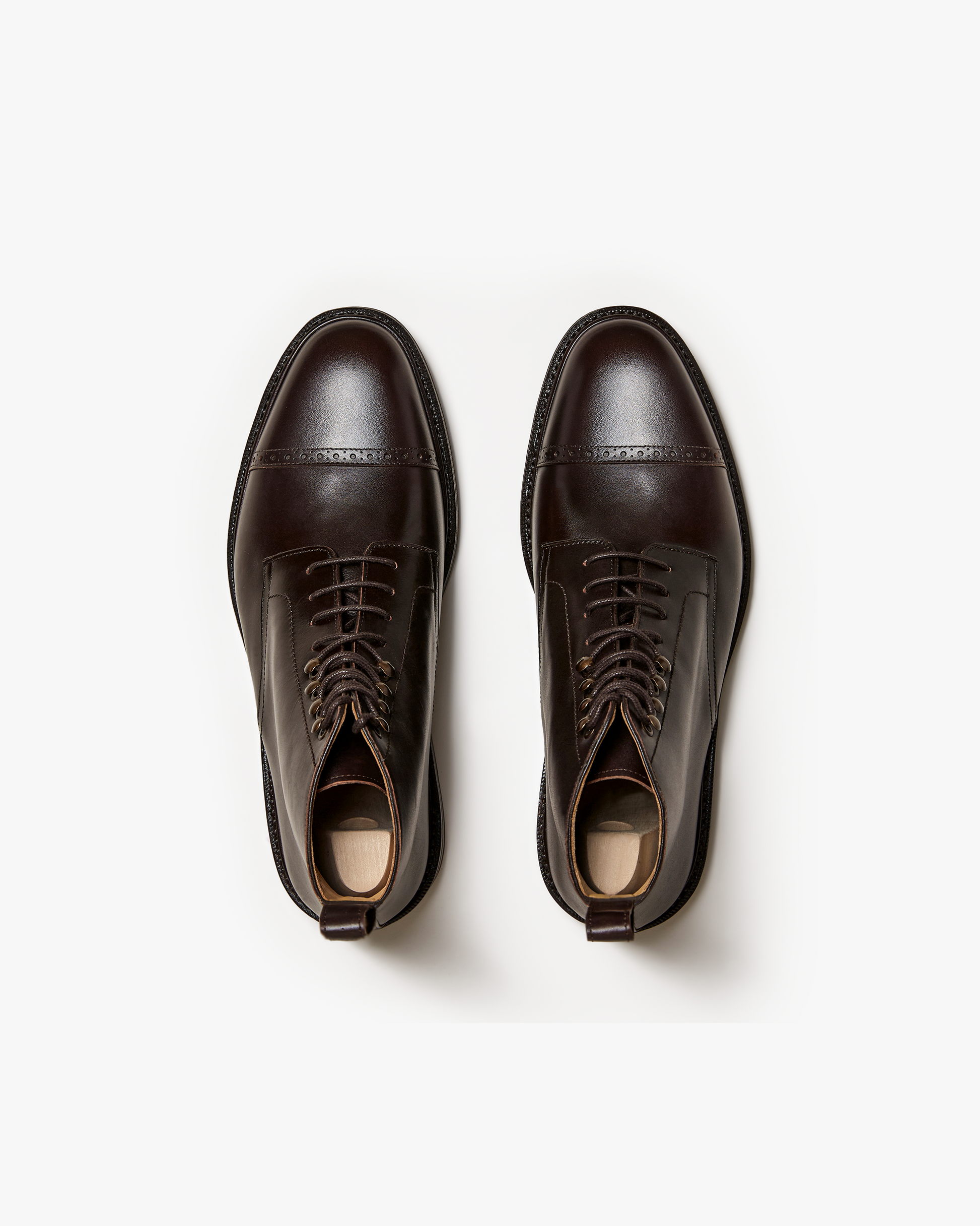 Tjärnö II in dark brown calf shown from above, highlighting the smooth full grain leather, cap toe with subtle broguing, rounded silhouette, and metal lace hooks for a refined yet versatile men's boot.