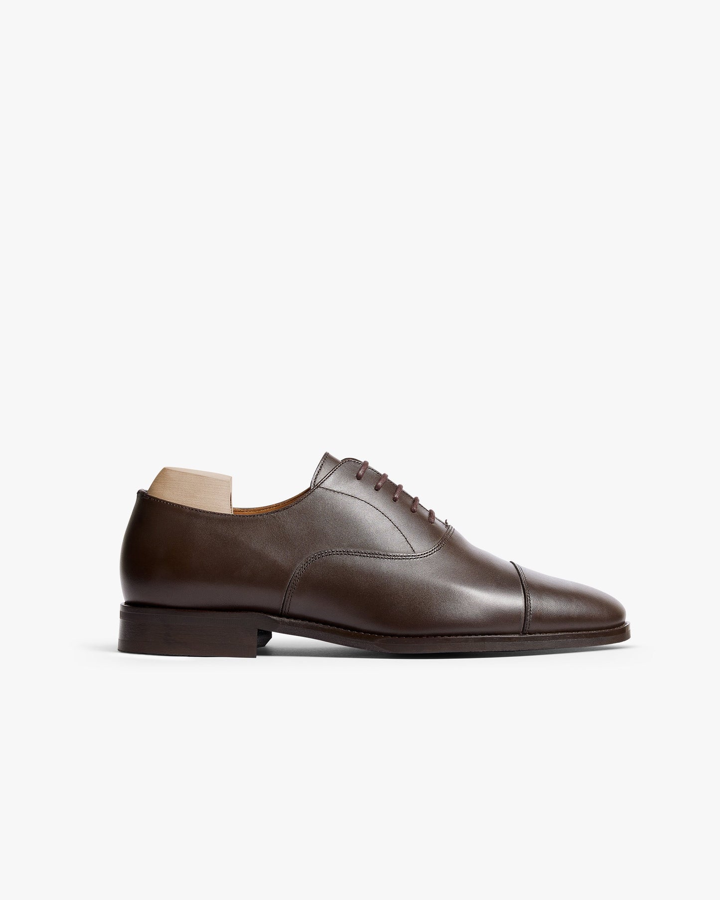 Vinterviken II in dark brown calf, a classic oxford shoe featuring a gently chiseled cap toe, clean lines, and subtle stitching, shown in a side profile against a white background.